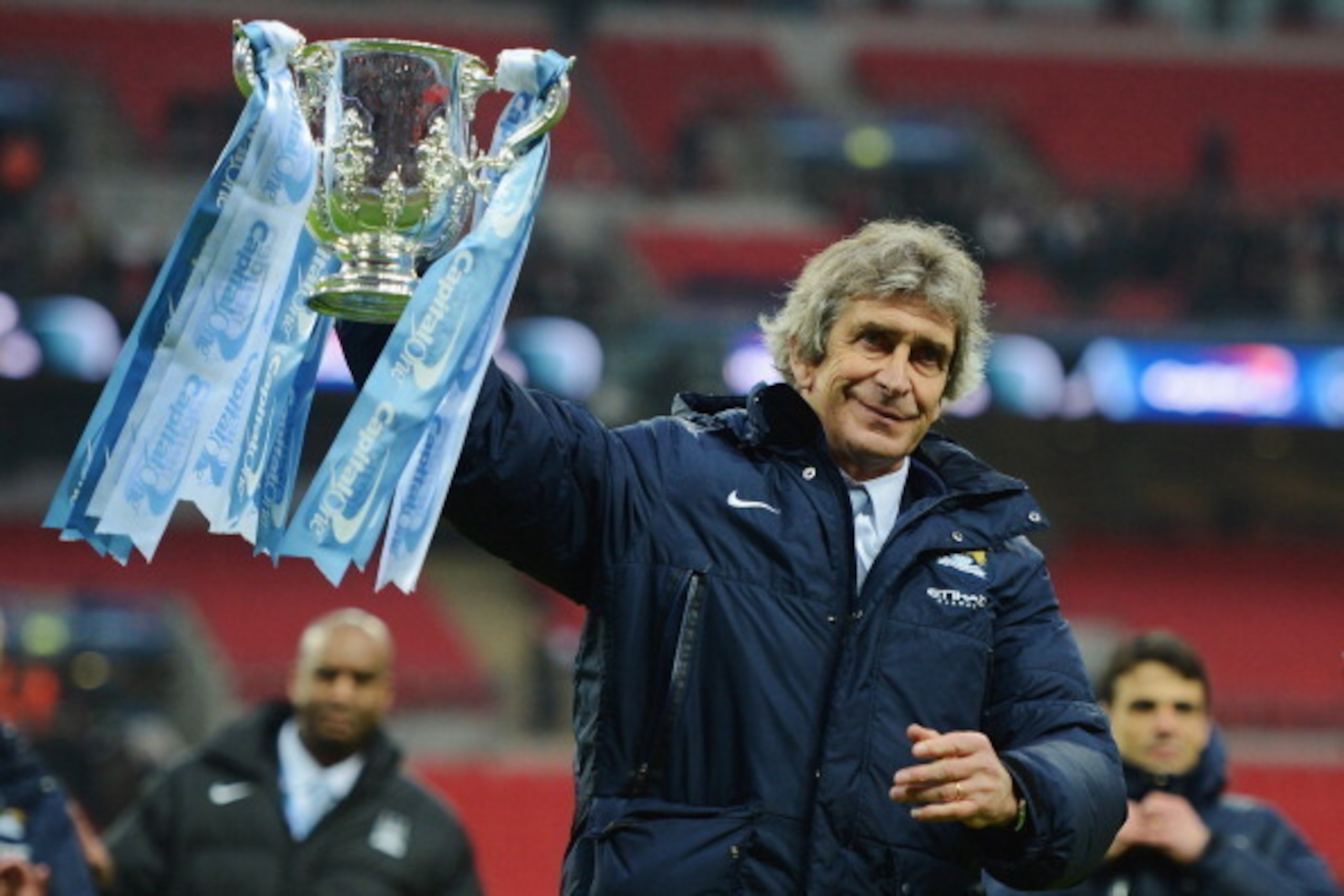 LONDON, ENGLAND - MARCH 02: Manuel Pellegrini, manager of Manchester City celebrates victory with the trophy after the Capital One Cup Final between Manchester City and Sunderland at Wembley Stadium on March 2, 2014 in London, England.  (Photo by Michael 
