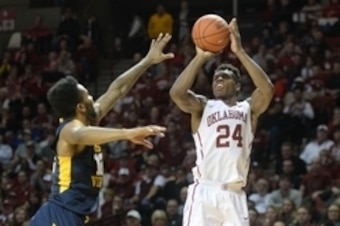 Jan 16, 2016; Norman, OK, USA; Oklahoma Sooners guard Buddy Hield (24) shoots the ball in front of West Virginia Mountaineers guard Tarik Phillip (12) during the second half at Lloyd Noble Center. Mandatory Credit: Mark D. Smith-USA TODAY Sports