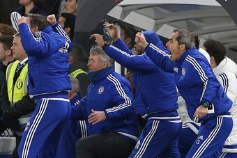 Members of the Chelsea staff including Chelsea's Dutch manager Guus Hiddink (2L), assistant first team coach Eddie Newton (2R) and goalkeeping coach Christophe Lollichon (R) celebrate a late equalising goal by Chelsea's English defender John Terry to make