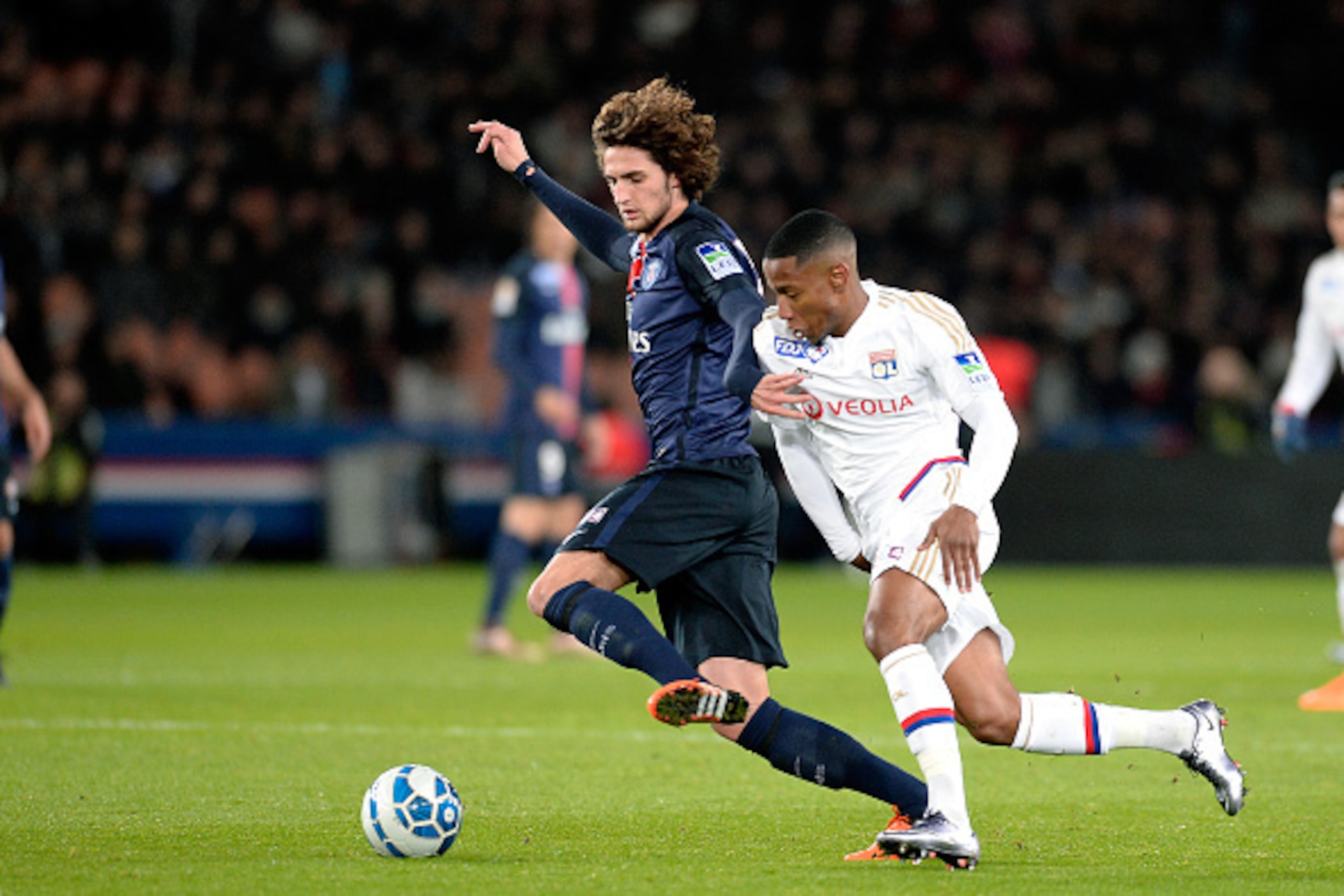 PARIS, FRANCE - JANUARY 13: Adrien Rabiot of Paris Saint-Germain and Claudio Beauvue of Olympique Lyonnais fight for the ball during the French League Cup game between Paris Saint-Germain and Olympique Lyonnais at Parc des Princes on January 13, 2016 in P PARIS, FRANCE - JANUARY 13: Adrien Rabiot of Paris Saint-Germain and Claudio Beauvue of Olympique Lyonnais fight for the ball during the French League Cup game between Paris Saint-Germain and Olympique Lyonnais at Parc des Princes on January 13, 2016 in P