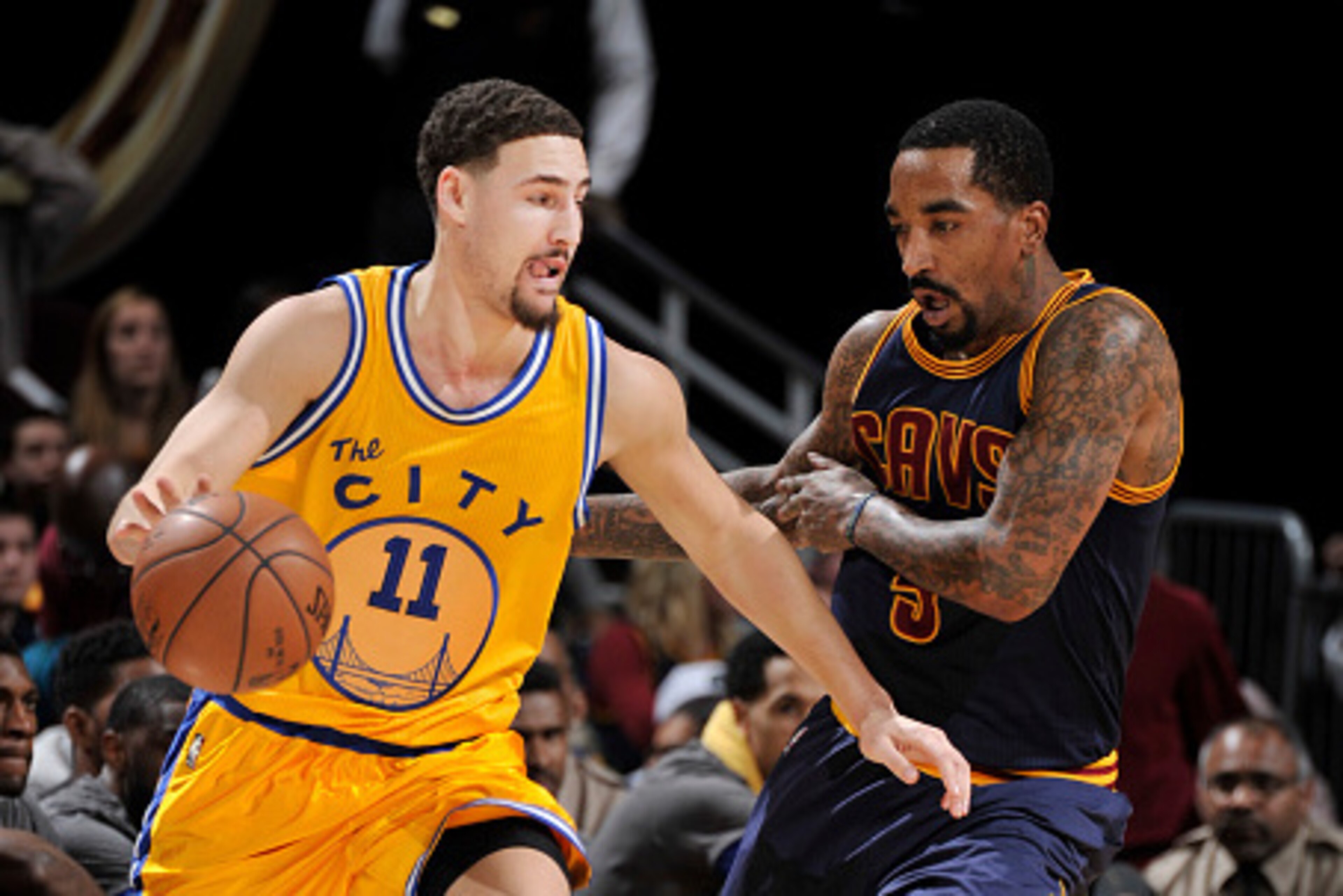 CLEVELAND, OH - JANUARY 18: Klay Thompson #11 of the Golden State Warriors drives the basket against J.R. Smith #5 of the Cleveland Cavaliers during the game on January 18, 2016 at Quicken Loans Arena in Cleveland, Ohio. NOTE TO USER: User expressly ackno