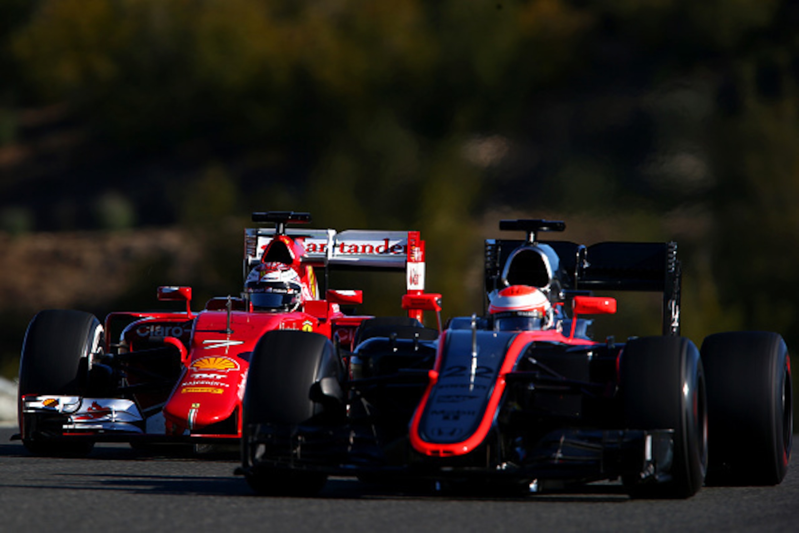 JEREZ DE LA FRONTERA, SPAIN - FEBRUARY 04:  Kimi Raikkonen of Finland and Ferrari and Jenson Button of Great Britain and McLaren Honda drive during day four of Formula One Winter Testing at Circuito de Jerez on February 4, 2015 in Jerez de la Frontera, Sp