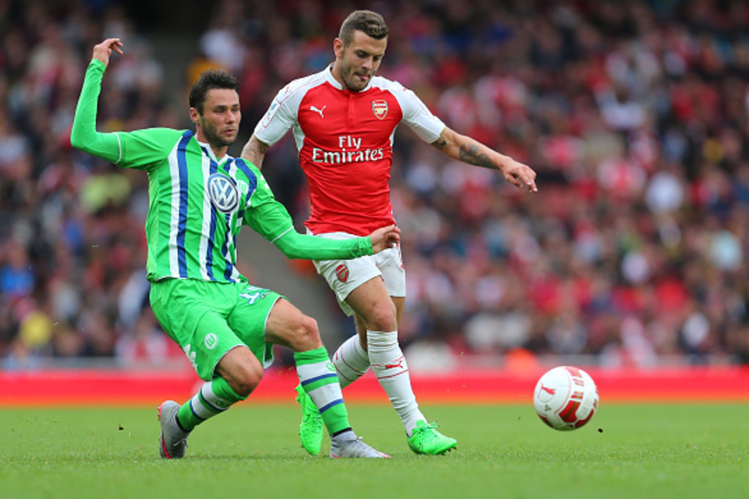 LONDON, ENGLAND - JULY 26:  Jack Wilshere of Arsenal and Christian Trasch of Wolfsburg during the Emirates Cup match between Arsenal and VfL Wolfsburg at Emirates Stadium on July 26, 2015 in London, England.  (Photo by Catherine Ivill - AMA/Getty Images).