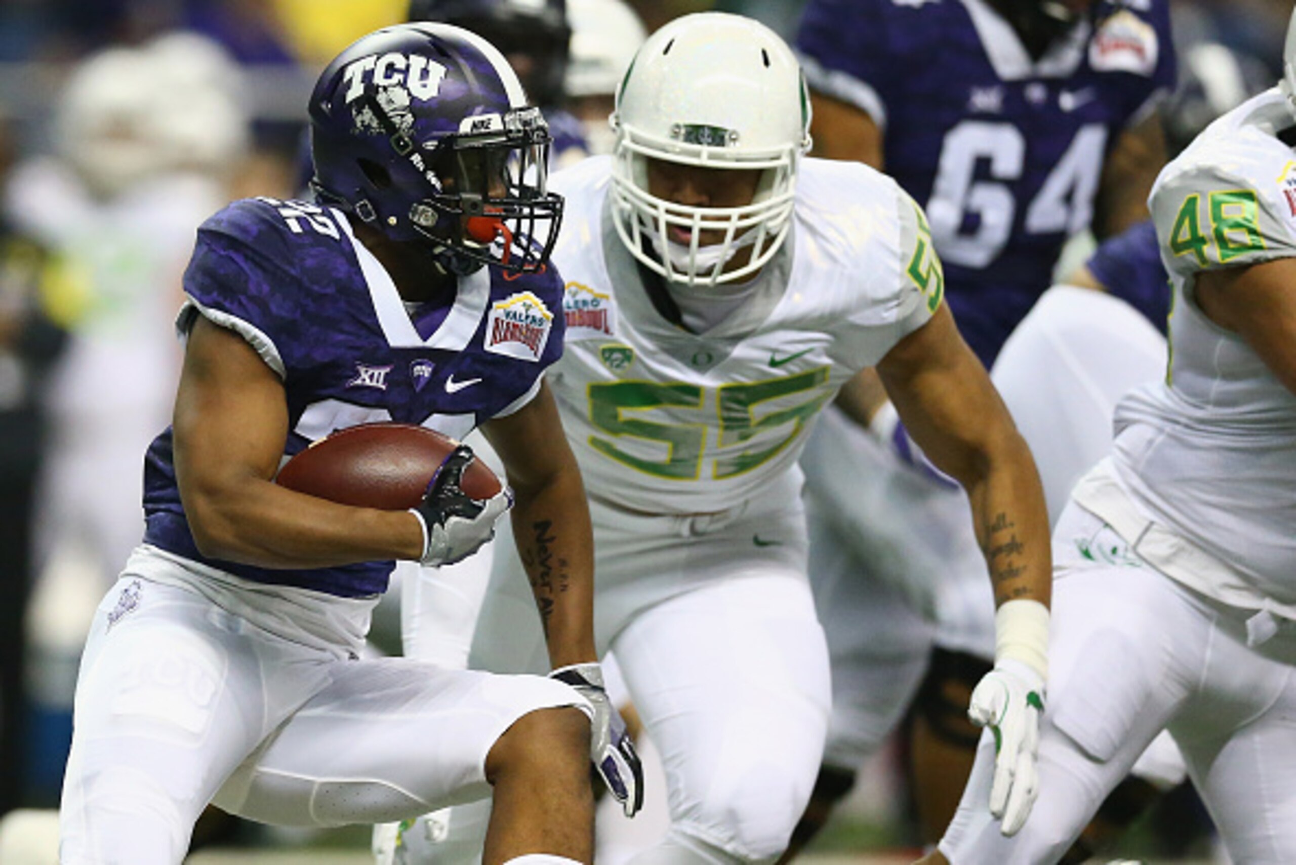 SAN ANTONIO, TX - JANUARY 02:  Aaron Green #22 of the TCU Horned Frogs runs the ball against the Oregon Ducks during the Valero Alamo Bowl at Alamodome on January 2, 2016 in San Antonio, Texas.  (Photo by Ronald Martinez/Getty Images)