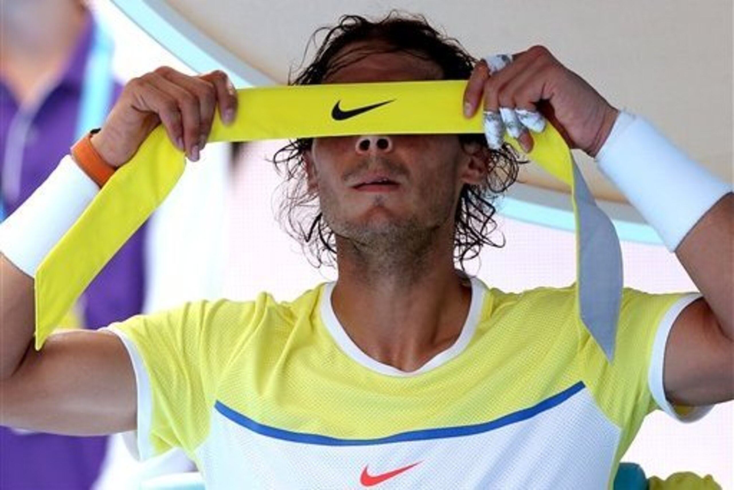 Rafael Nadal removes his headband after losing his first-round match at the 2016 Australian Open.