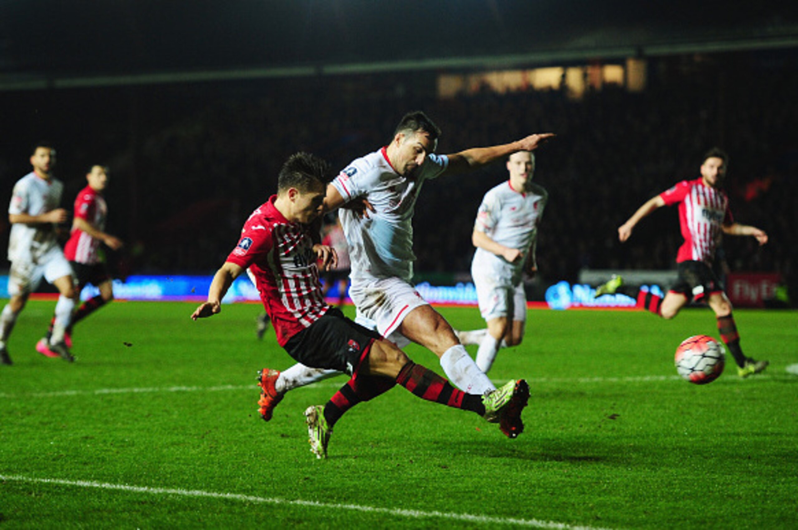 EXETER, ENGLAND - JANUARY 08:  Jose Enrique of Liverpool challenges Tom Nichols of Exeter City as he shoots during the Emirates FA Cup third round match between Exeter City and Liverpool at St James Park on January 8, 2016 in Exeter, England.  (Photo by D
