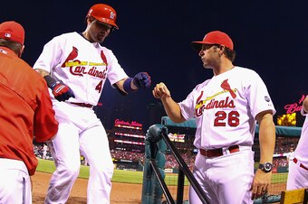 ST. LOUIS, MO - AUGUST 17: Yadier Molina #4 of the St. Louis Cardinals is congratulated by managaer Mike Matheny #26 after hitting a solo home run against the San Francisco Giants in the fourth inning at Busch Stadium on August 17, 2015 in St. Louis, Miss