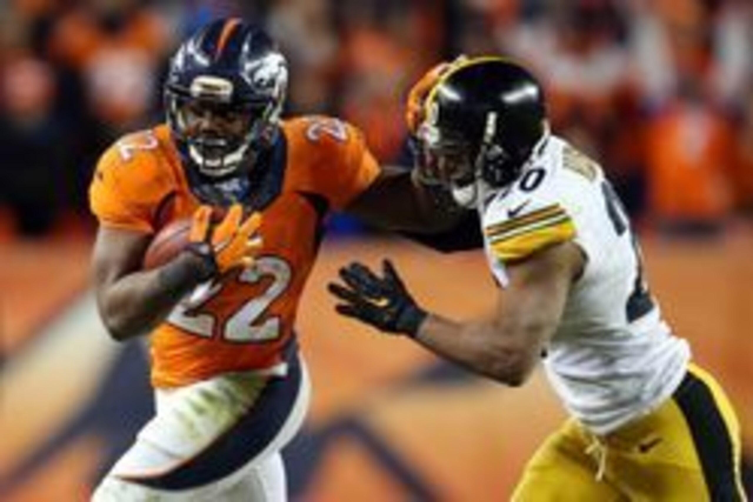 Jan 17, 2016; Denver, CO, USA; Denver Broncos running back C.J. Anderson (22) runs against Pittsburgh Steelers strong safety Will Allen (20) during the fourth quarter of the AFC Divisional round playoff game at Sports Authority Field at Mile High. Mandato