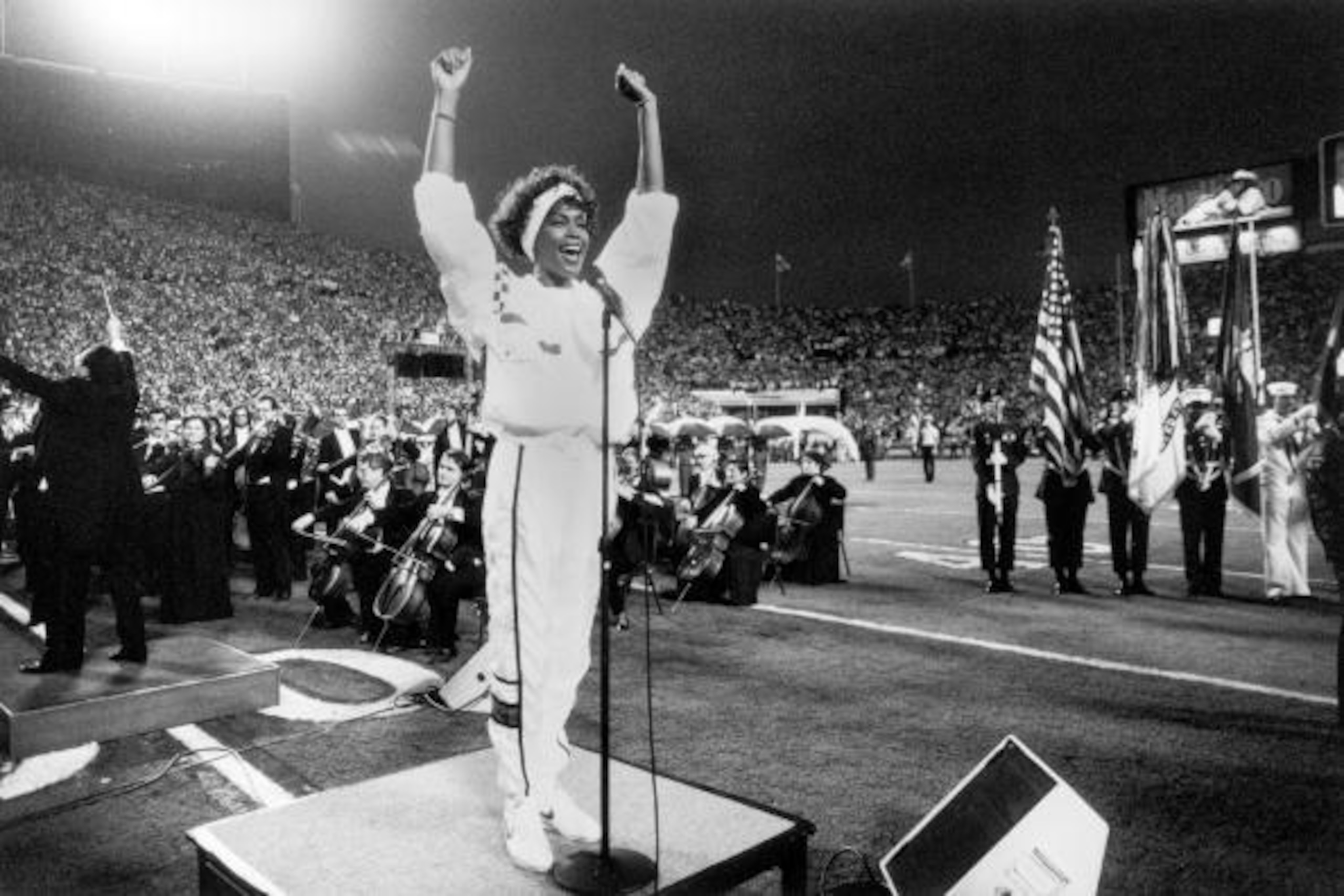 TAMPA, FL - JANUARY 27:  Whitney Houston sings the National Anthem prior to Super Bowl XXV between the New York Giants and Buffalo Bills at Tampa Stadium on January 27, 1991 in Tampa, Florida. The Giants defeated the Bills 20-19.  (Photo by Michael Zagari