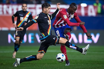 MADRID, SPAIN - JANUARY 14: Jackson Arley Martinez (R) of Atletico de Madrid strikes the ball over Ze Castro (L) of Rayo Vallecano de Madrid during the Copa del Rey Round of 16 second leg match between Club Atletico Madrid and Rayo Vallecano de Madrid at 