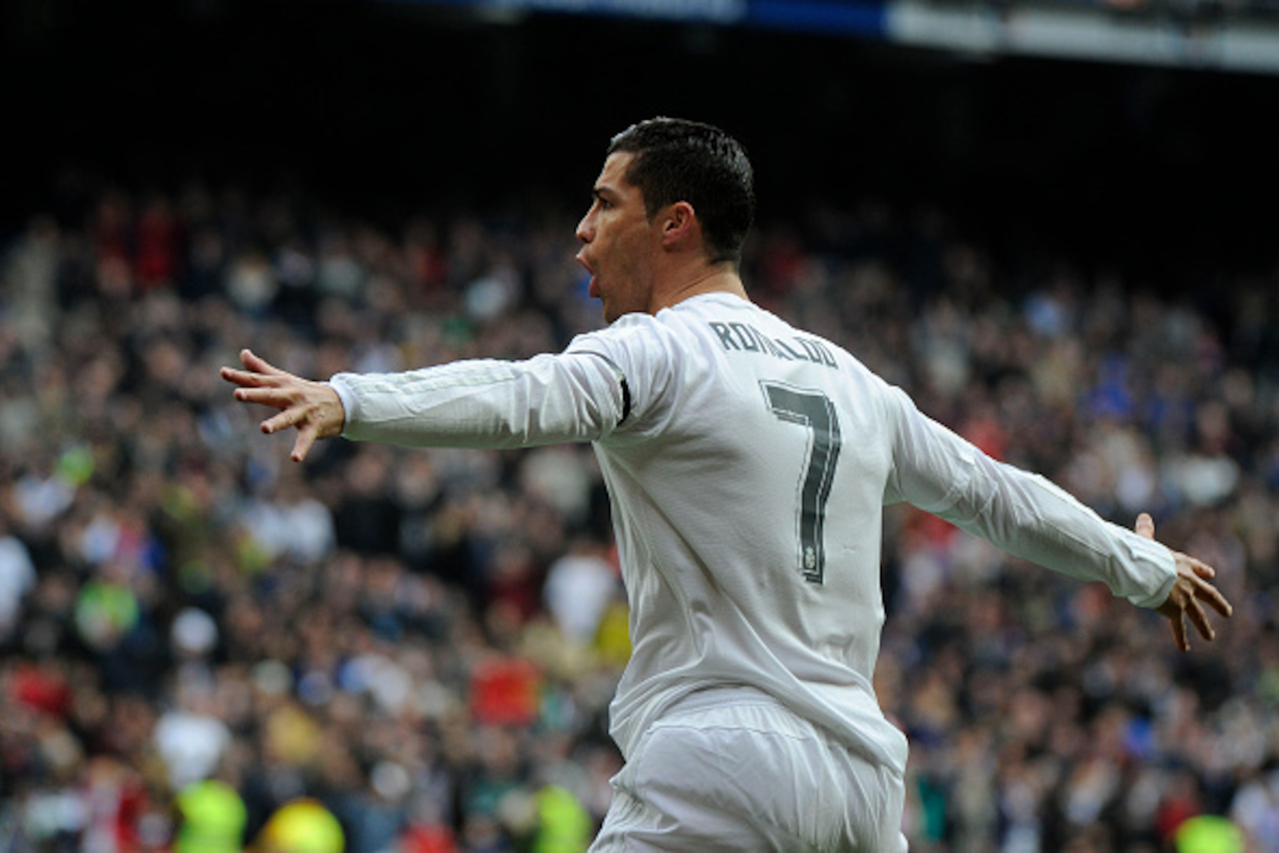 Real Madrid's Portuguese forward Cristiano Ronaldo celebrates after scoring during the Spanish league football match Real Madrid CF vs Real Sporting de Gijon at the Santiago Bernabeu stadium in Madrid on January 17, 2016.   AFP PHOTO/ PEDRO ARMESTRE / AFP