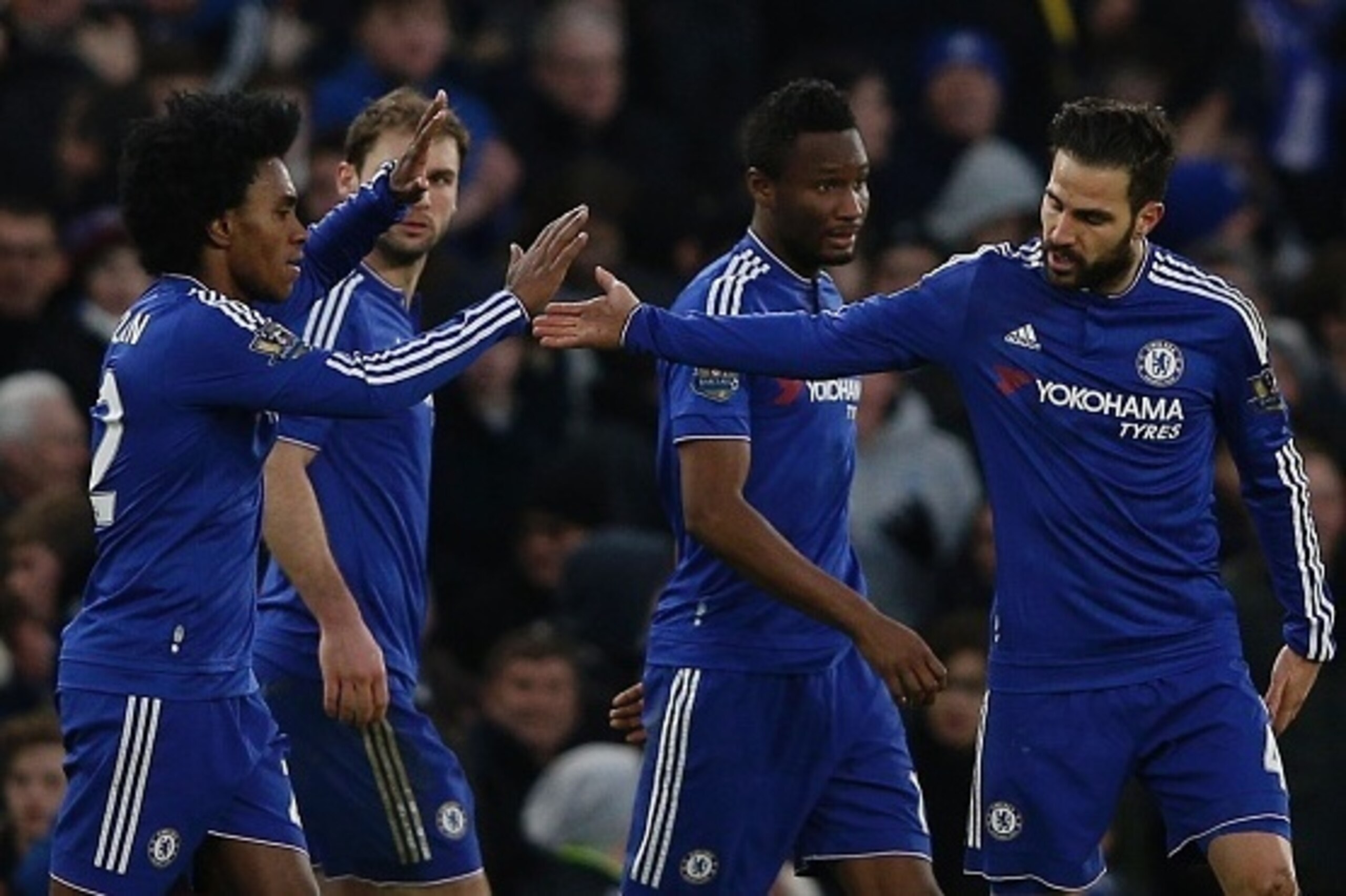 Chelsea's Spanish midfielder Cesc Fabregas (R) celebrates with Chelsea's Brazilian midfielder Willian (L) after scoring Chelsea's second goal to equalise 2-2 during the English Premier League football match between Chelsea and Everton at Stamford Bridge i