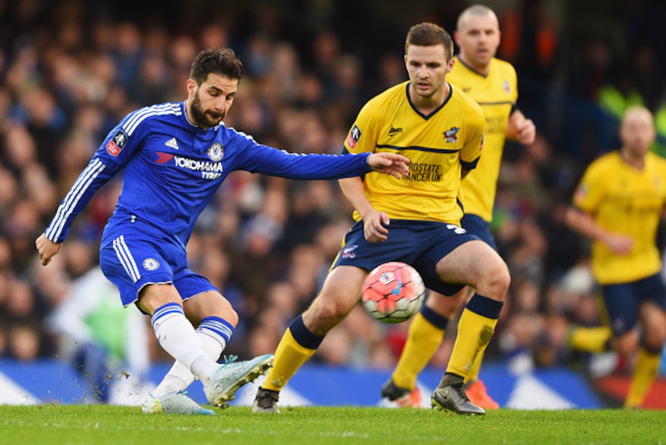 LONDON, ENGLAND - JANUARY 10:  Cesc Fabregas of Chelsea is watched by Jamie Ness of Scunthorpe United during the Emirates FA Cup third round match between Chelsea and Scunthorpe United at Stamford Bridge on January 10, 2016 in London, England.  (Photo by 