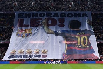 Barcelona supporters display a giant banner reading 'Congratulations Leo' (for Barcelona's Argentinian forward Lionel Messi) before the Spanish league football match FC Barcelona vs Athletic Club Bilbao at the Camp Nou stadium in Barcelona on January 17, 