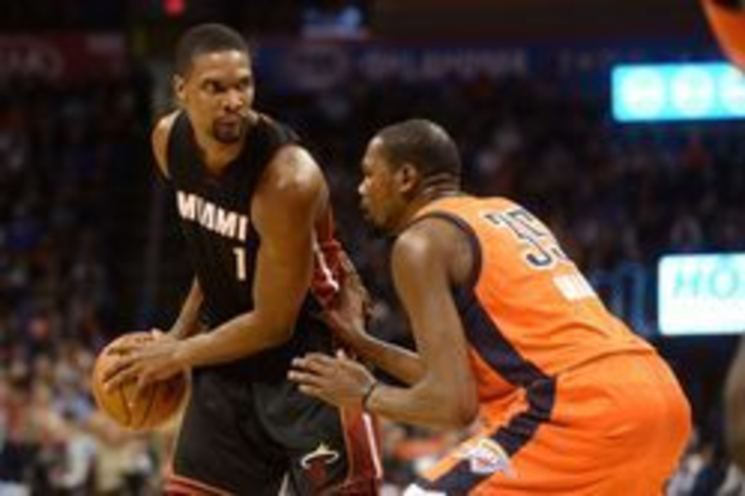 Jan 17, 2016; Oklahoma City, OK, USA;  Miami Heat forward Chris Bosh (1) handles the ball against Oklahoma City Thunder forward Kevin Durant (35) during the second quarter at Chesapeake Energy Arena. Mandatory Credit: Mark D. Smith-USA TODAY Sports