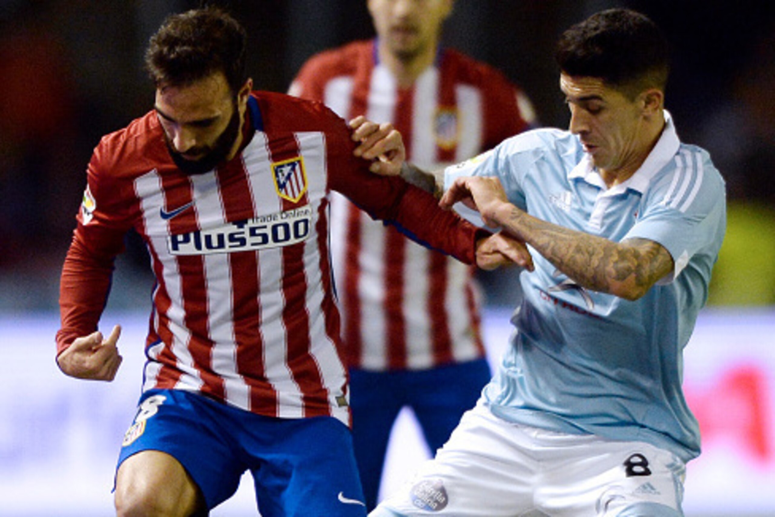 Atletico Madrid's defender Jesus Gamez (L) vies with Celta Vigo's Chilean midfielder Pablo Hernandez during the Spanish Copa del Rey (King's Cup) football match Celta Vigo vs Club Atletico de Madrid at the Balaidos stadium in Vigo on January 20, 2016.  AF