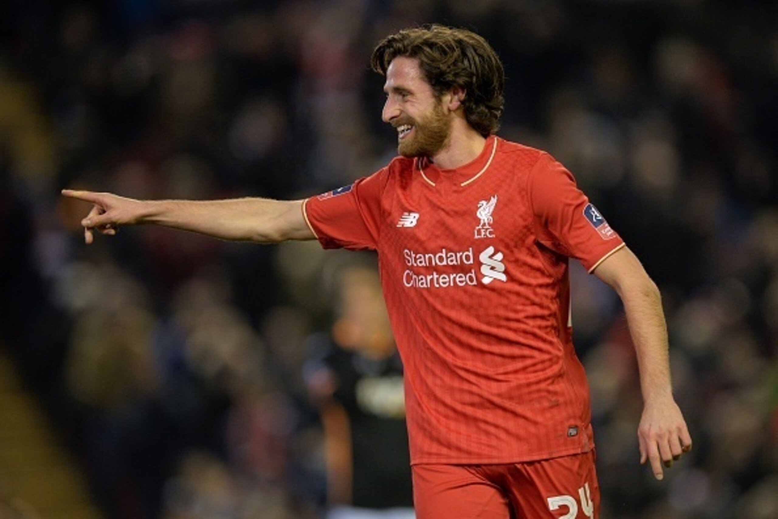 Liverpool's Welsh midfielder Joe Allen celebrates after scoring the opening goal of the English FA Cup third round replay football match between Liverpool and Exeter City at Anfield in Liverpool, north west England on January 20, 2016. AFP PHOTO / PAUL EL