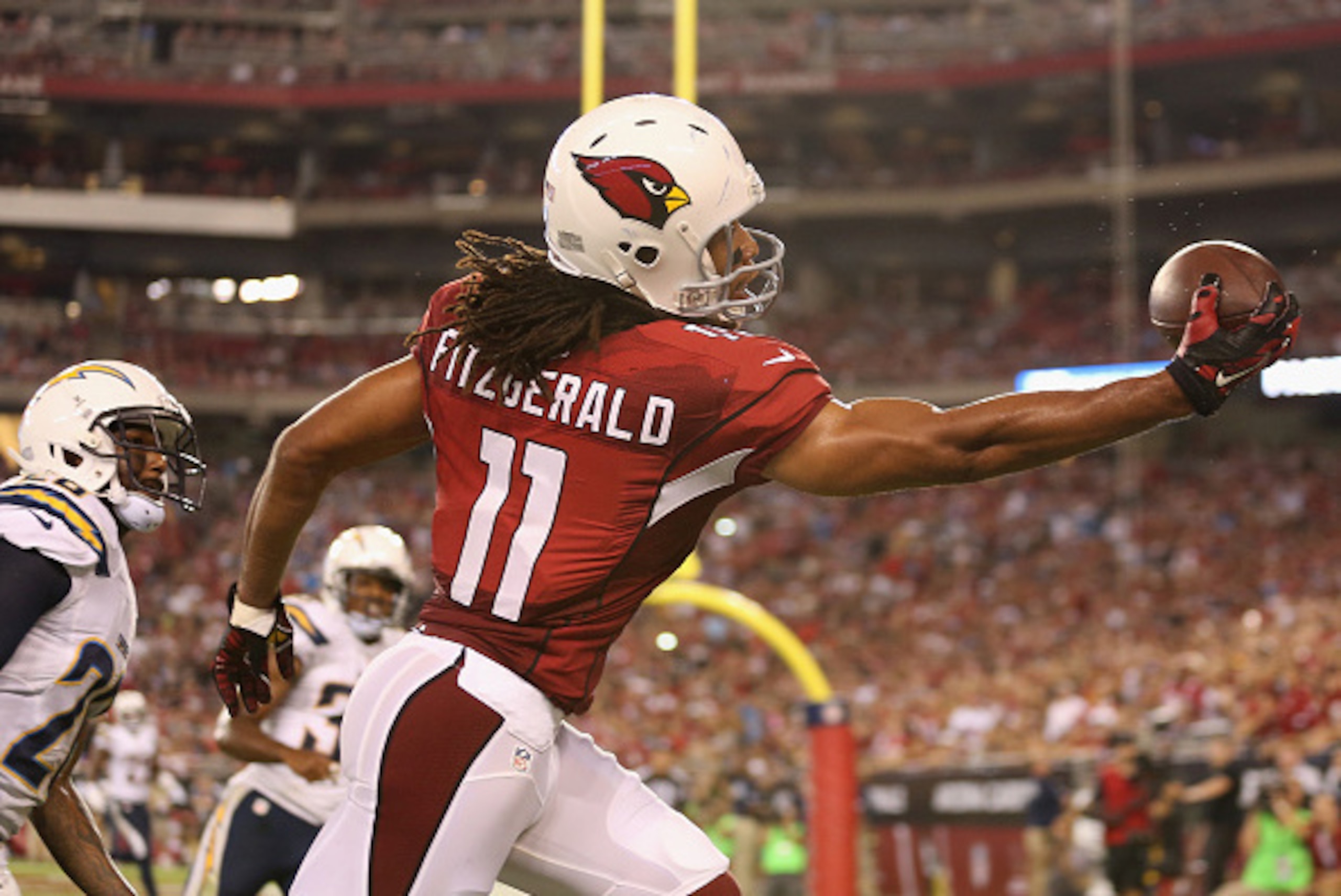 GLENDALE, AZ - SEPTEMBER 08:  Wide receiver Larry Fitzgerald #11 of the Arizona Cardinals attempts to catch a pass during the NFL game against the San Diego Chargers at the University of Phoenix Stadium on September 8, 2014 in Glendale, Arizona. The Cardi
