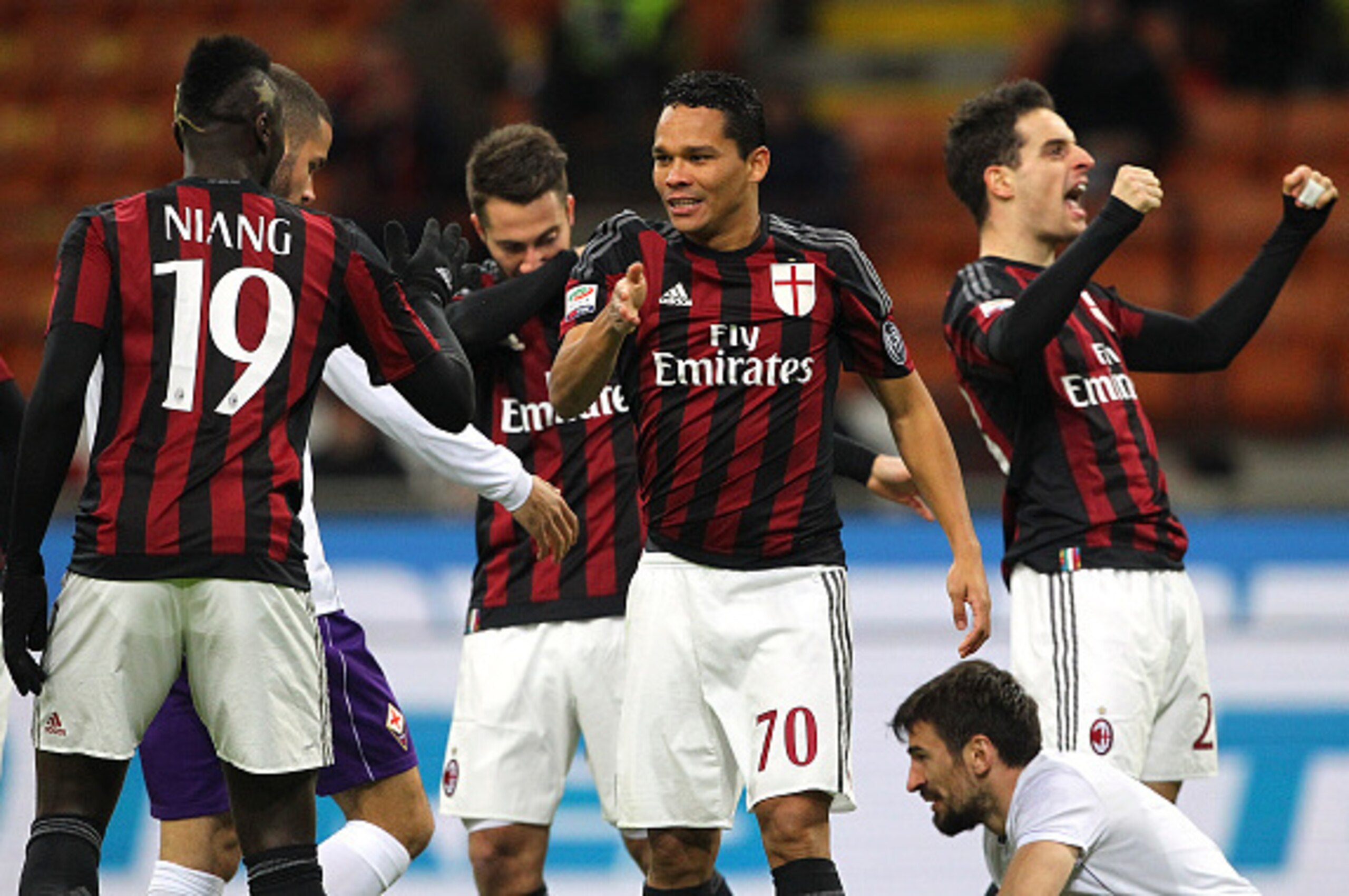 MILAN, ITALY - JANUARY 17:  Carlos Bacca (C) of AC Milan celebrates with his team-mate M Baye Niang #19 after scoring the opening goal during the Serie A match between AC Milan and ACF Fiorentina at Stadio Giuseppe Meazza on January 17, 2016 in Milan, Ita