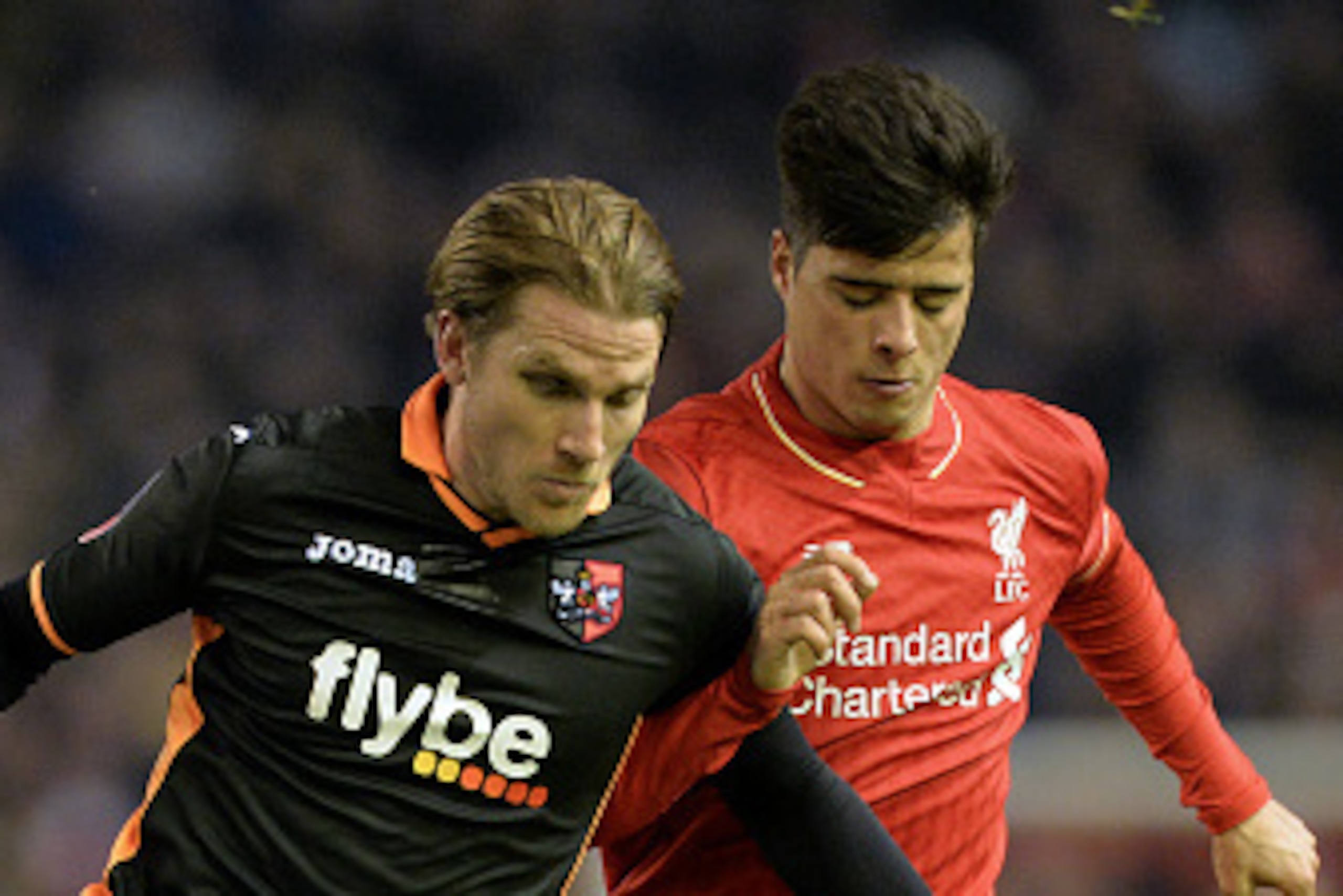 Exeter City's Welsh defender Christian Ribeiro (L) vies with Liverpool's Portuguese midfielder Joao Carlos Teixeira during the English FA Cup third round replay football match between Liverpool and Exeter City at Anfield in Liverpool, north west England o