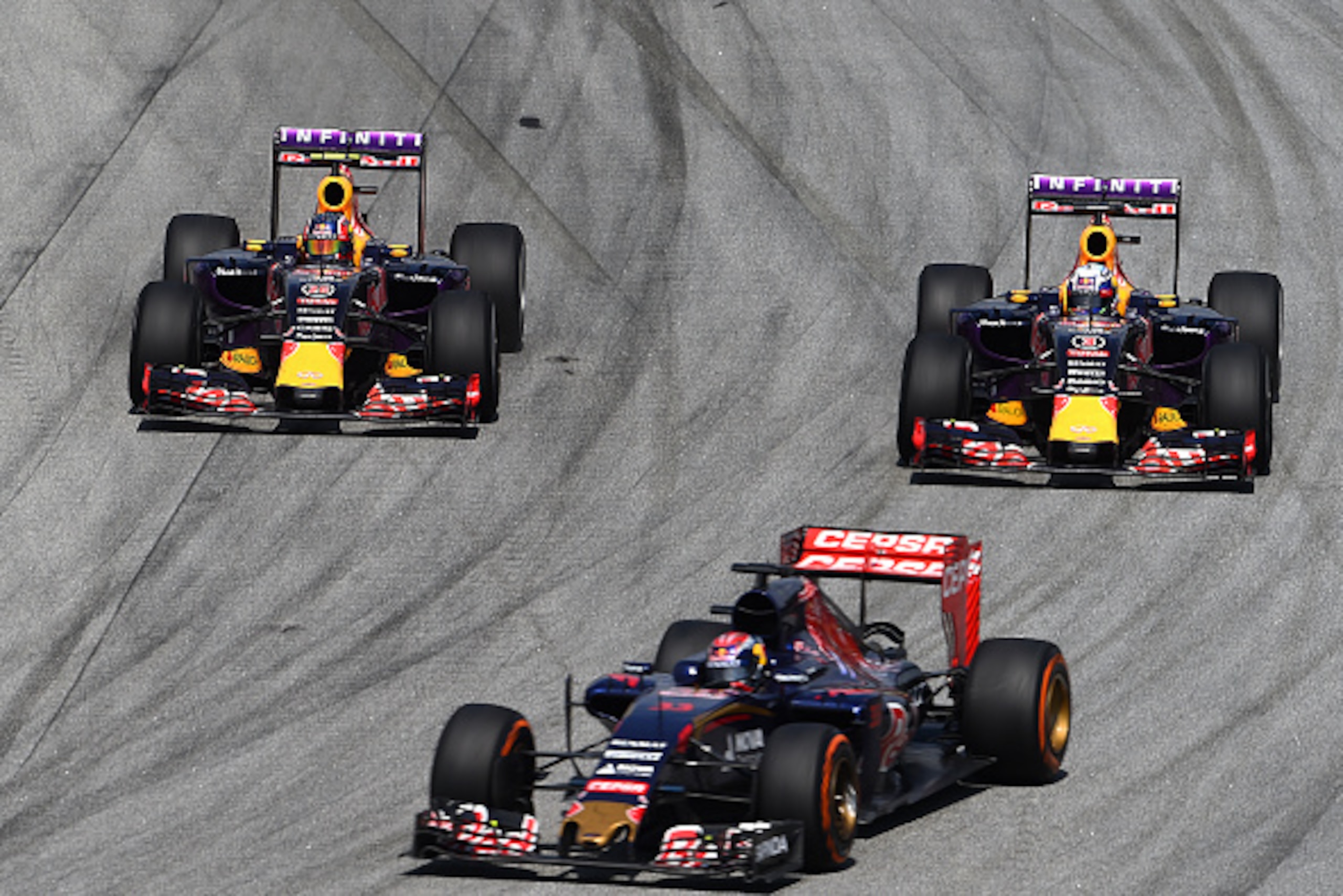 KUALA LUMPUR, MALAYSIA - MARCH 29:  Daniel Ricciardo of Australia and Infiniti Red Bull Racing and Daniil Kvyat of Russia and Infiniti Red Bull Racing drive next to Max Verstappen of Netherlands and Scuderia Toro Rosso during the Malaysia Formula One Gran
