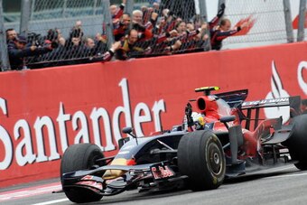 Toro Rosso's German driver Sebastien Vettel, congratulated by his team members, celebrates as he crosses the finish line of the Monza racetrack on September 14, 2008 near Milan, after the Italian Formula One Grand Prix. Toro Rosso's German driver Sebastie