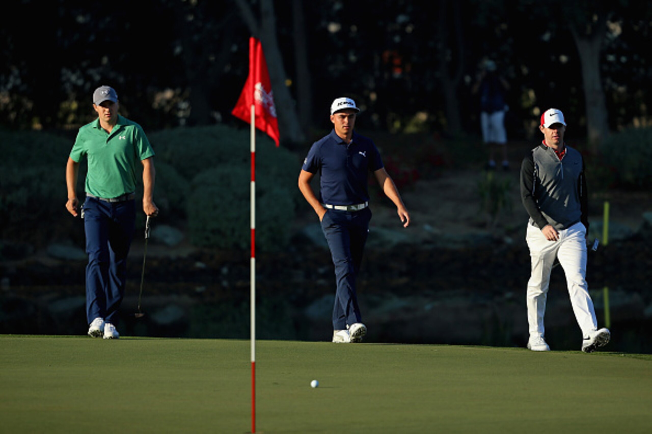 ABU DHABI, UNITED ARAB EMIRATES - JANUARY 21: (L-R) Jordan Spieth of the USA, Rickie Fowler of the USA and Rory McIlroy of Northern Ireland walk onto the 12th green during the first round of the Abu Dhabi HSBC Golf Championship at the Abu Dhabi Golf Cub ABU DHABI, UNITED ARAB EMIRATES - JANUARY 21: (L-R) Jordan Spieth of the USA, Rickie Fowler of the USA and Rory McIlroy of Northern Ireland walk onto the 12th green during the first round of the Abu Dhabi HSBC Golf Championship at the Abu Dhabi Golf Cub
