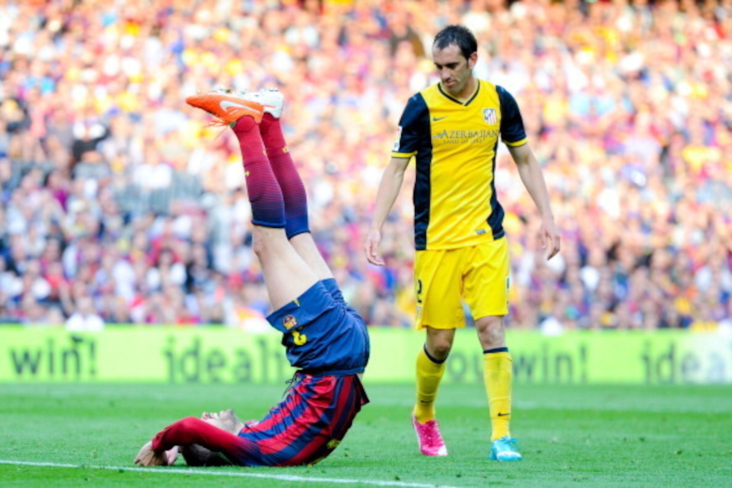 BARCELONA, SPAIN - MAY 17: Diego Godin of Atletico de Madrid looks at Gerard Pique of FC Barcelona as he reacts on the pitch during the La Liga match between FC Barcelona and Club Atletico de Madrid at Camp Nou on May 17, 2014 in Barcelona, Spain. Atleti BARCELONA, SPAIN - MAY 17: Diego Godin of Atletico de Madrid looks at Gerard Pique of FC Barcelona as he reacts on the pitch during the La Liga match between FC Barcelona and Club Atletico de Madrid at Camp Nou on May 17, 2014 in Barcelona, Spain. Atleti