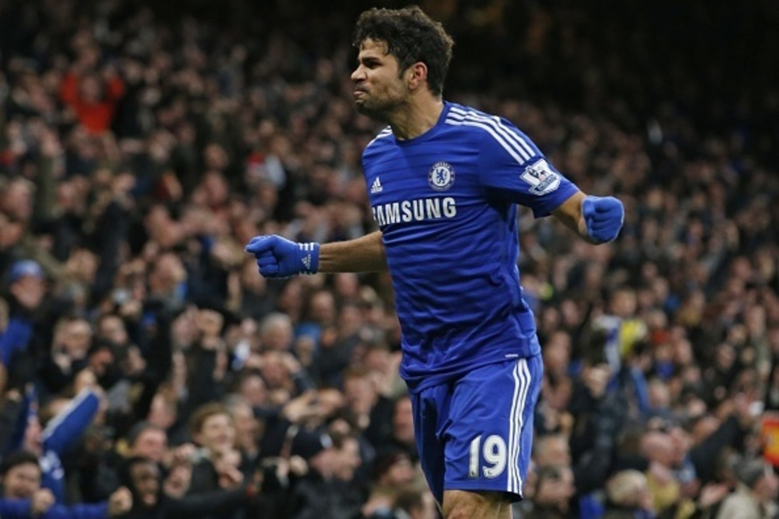 Chelsea's Brazilian-born Spanish striker Diego Costa celebrates scoring their second goal during the English Premier League football match between Chelsea and West Ham United at Stamford Bridge in London on December 26, 2014. AFP PHOTO / JUSTIN TALLIS

==