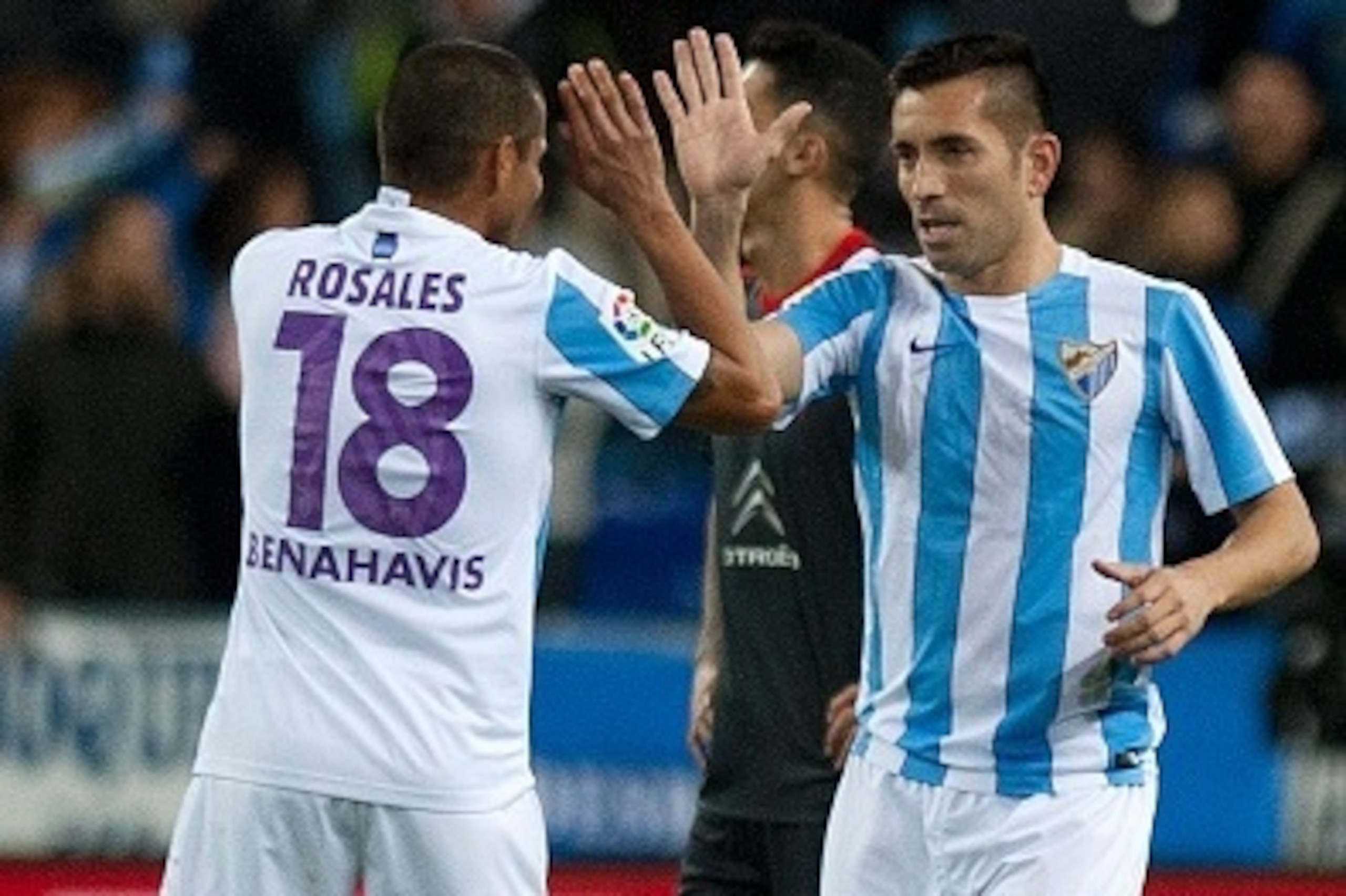 Malaga's Brazilian forward Charles Dias de Oliveira (R) celebrates with Venezuelan defender Roberto Jose Rosales after scoring during the Spanish league football match Malaga CF vs RC Celta de Vigo at La Rosaleda stadium in Malaga on January 2, 2016.   AF