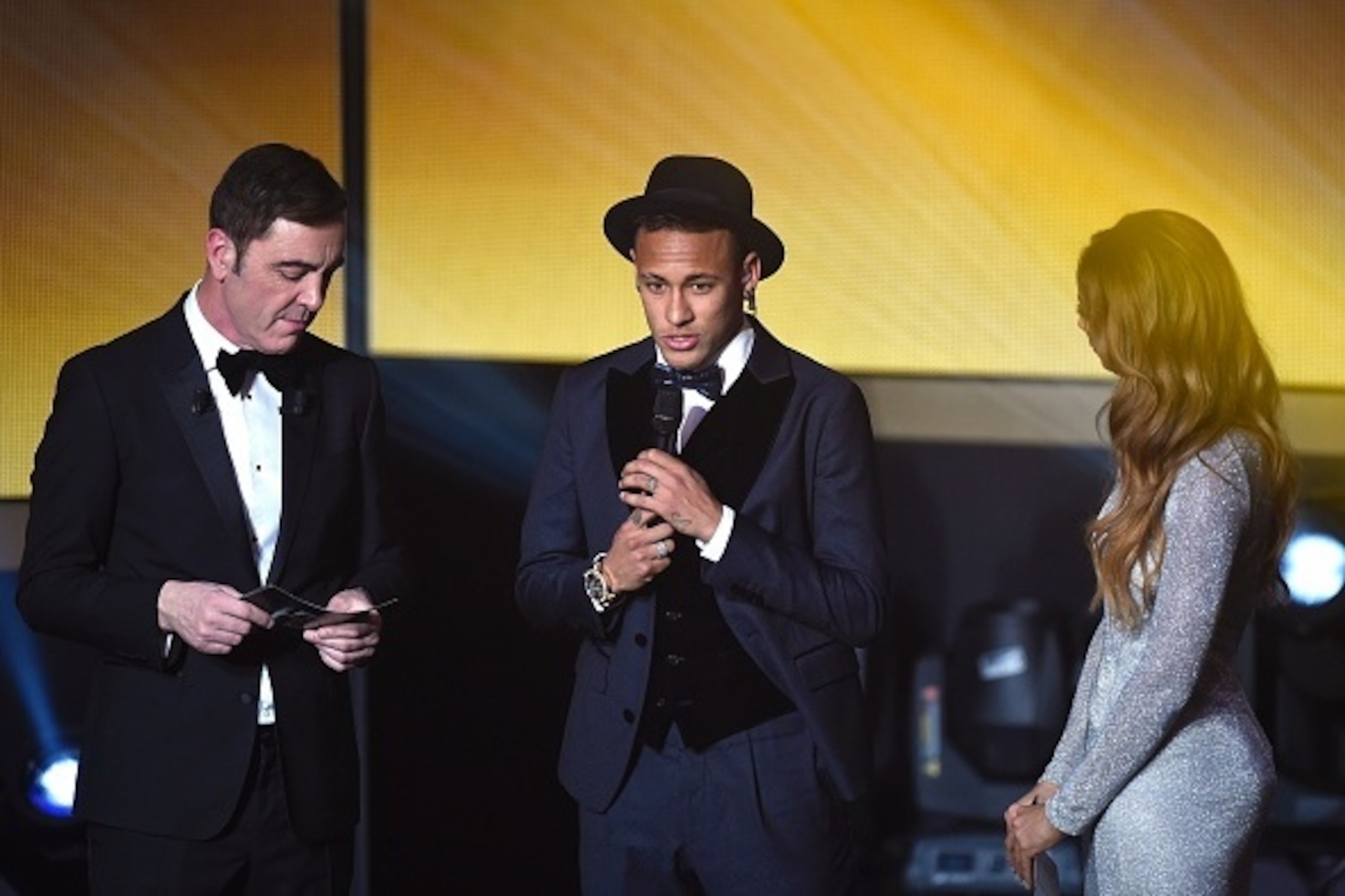 FC Barcelona and Brazils forward  Neymar (C) speaks next to Northern Irish actor and host James Nesbitt (L) and British presenter and host Kate Abdo (R) during the 2015 FIFA Ballon d'Or award ceremony at the Kongresshaus in Zurich on January 11, 2016. AFP