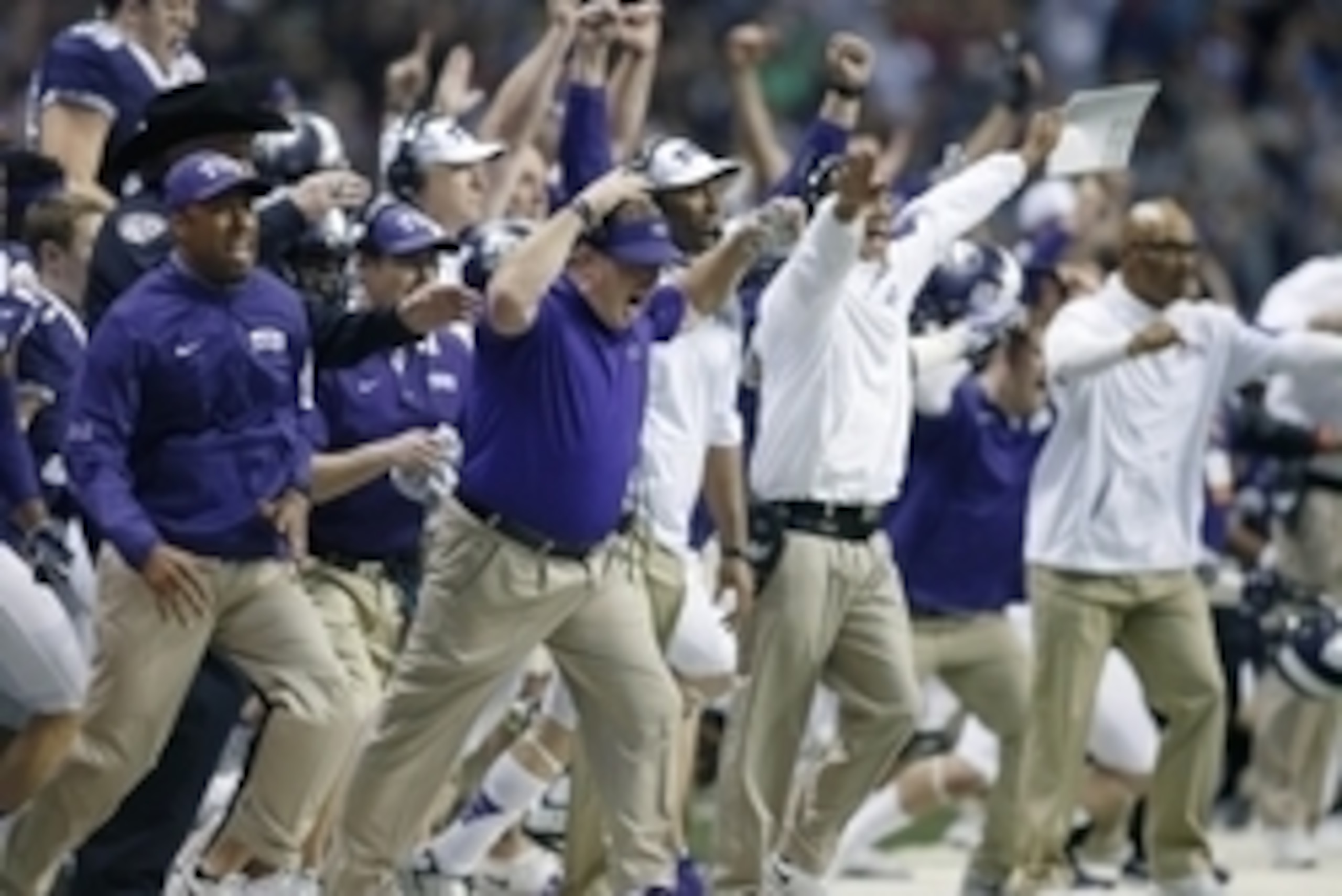 Jan 2, 2016; San Antonio, TX, USA; Texas Christian Frogs head coach Gary Patterson (center with visor), along with coaches and players rush the field after defeating the Oregon Ducks 47-41 in overtime at the Alamo Bowl in the Alamodome. Mandatory Credit: 
