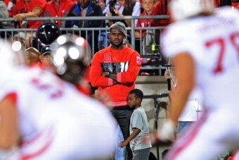 COLUMBUS, OH - SEPTEMBER 28:  NBA player LeBron James watches from the sidelines as the Ohio State Buckeyes play the Wisconsin Badgers at Ohio Stadium on September 28, 2013 in Columbus, Ohio.  (Photo by Jamie Sabau/Getty Images)