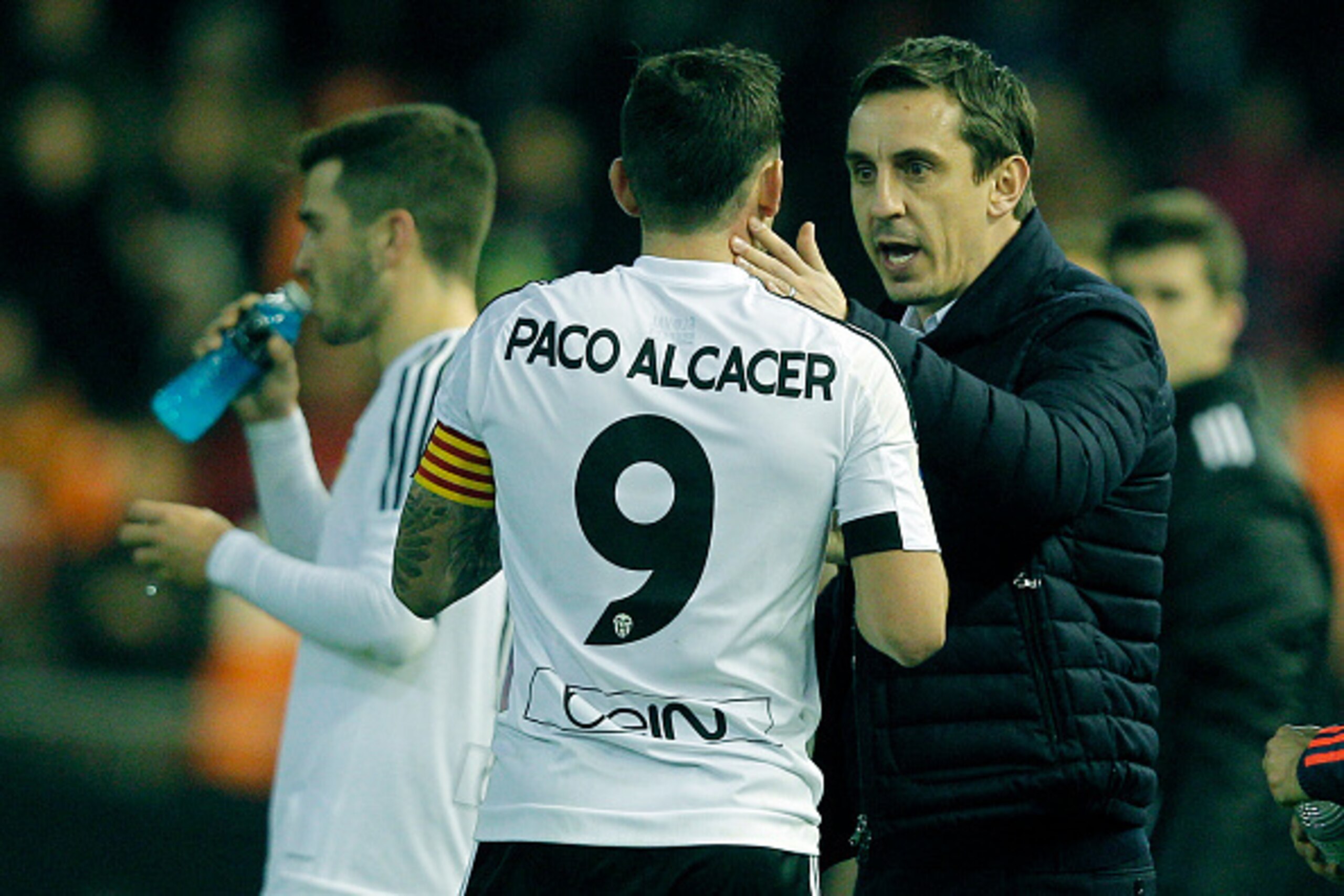 Valencia's British coach Gary Neville (R) speaks with Valencia's forward Paco Alcacer during the Spanish Copa del Rey (King's Cup) football match Valencia CF vs UD Las Palmas at the Mestalla stadium in Valencia on January 21, 2016. AFP PHOTO / JOSE JORDAN