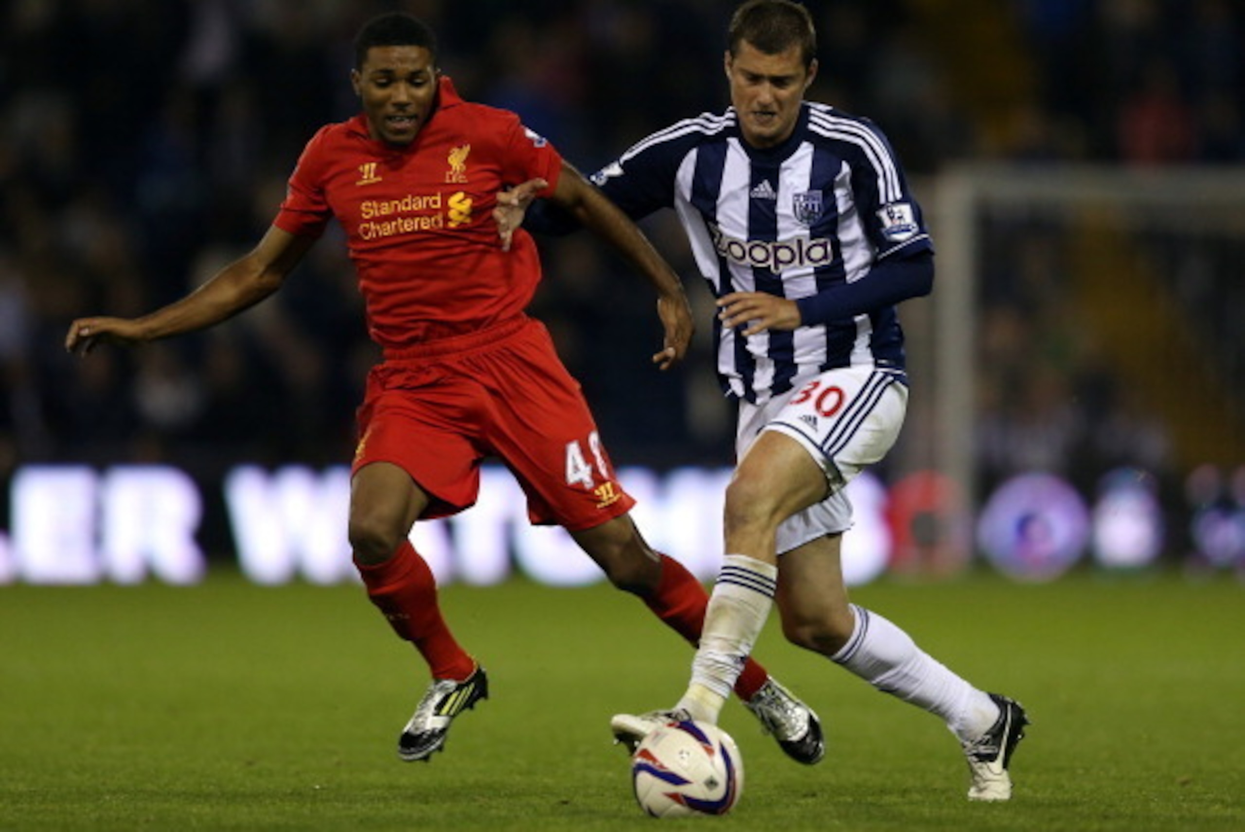 WEST BROMWICH, ENGLAND - SEPTEMBER 26:  Jerome Sinclair of Liverpool battles with Gabriel Tamas of West Brom during the Capital One Cup third round match between West Bromwich Albion and Liverpool at The Hawthorns on September 26, 2012 in West Bromwich, E