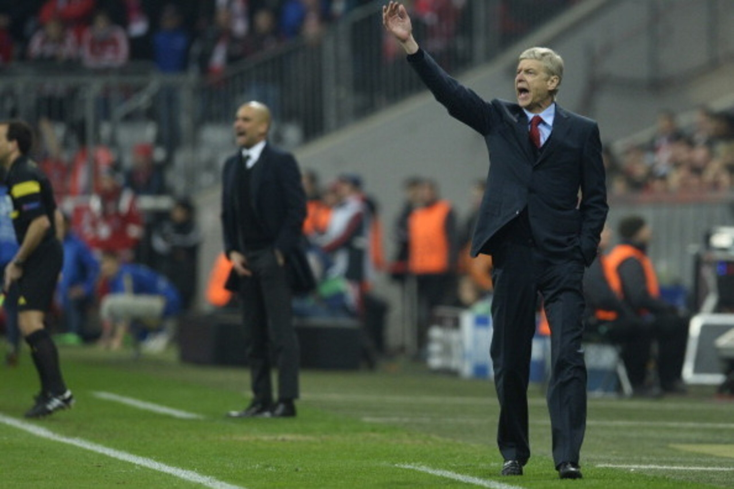 Arsenal's French manager Arsene Wenger (R) and Bayern Munich's Spanish head coach Pep Guardiola react during the UEFA Champions League last 16 second-leg football match FC Bayern Munich vs FC Arsenal in Munich, southern Germany, on March 11, 2014.   AFP P