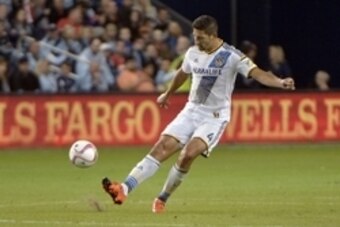 Oct 25, 2015; Kansas City, KS, USA; Los Angeles Galaxy defender Omar Gonzalez (4) passes the ball during the second half of the match against Sporting KC at Sporting Park. Sporting KC won the match 2-1. Mandatory Credit: Denny Medley-USA TODAY Sports