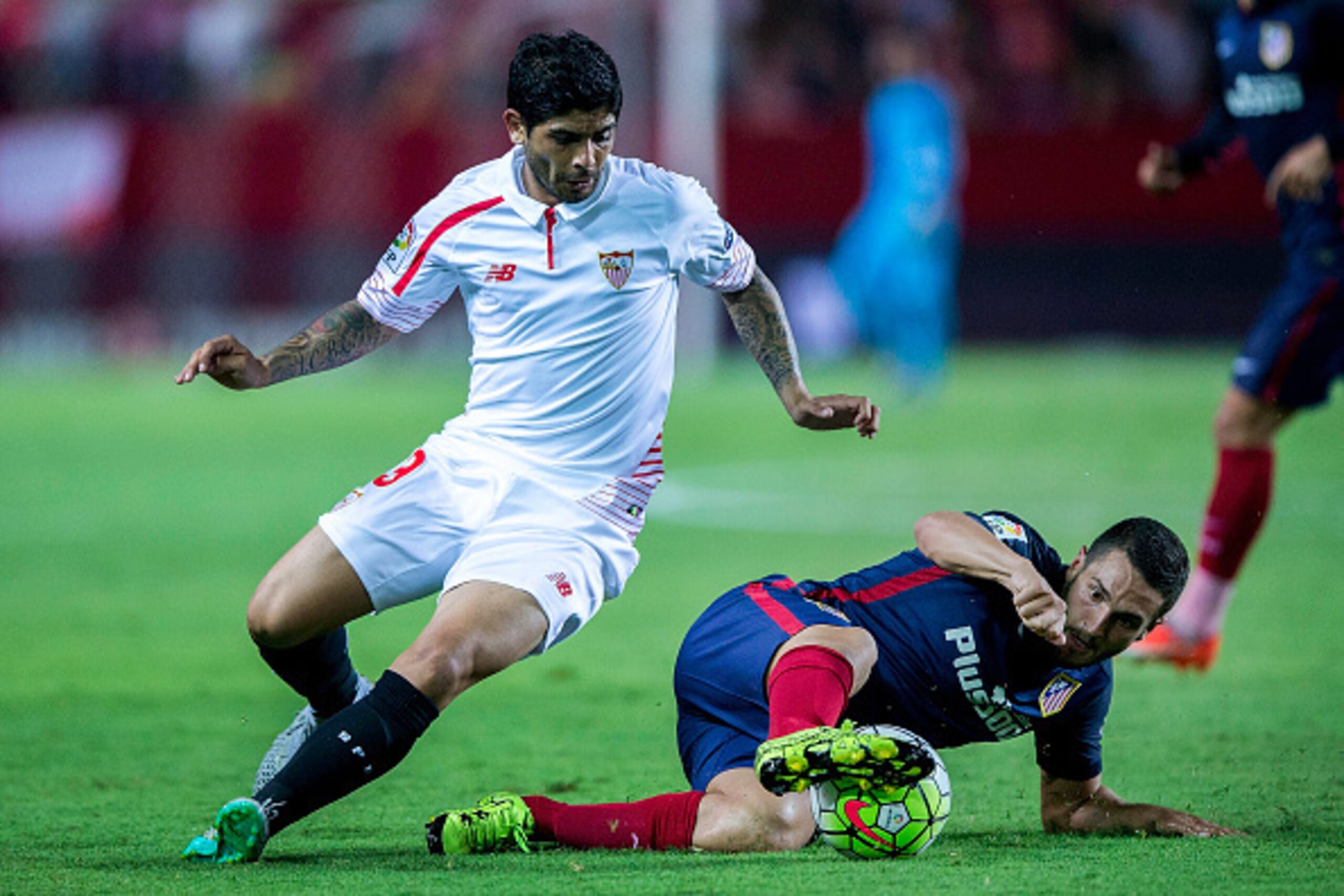 SEVILLE, SPAIN - AUGUST 30: Koke (R) of Atletico de Madrid competes for the ball with Ever Banega (L) of Sevilla FC during the La Liga match between Sevilla FC and Club Atletico de Madrid at Estadio Ramon Sanchez Pizjuan on August 30, 2015 in Seville, Spa
