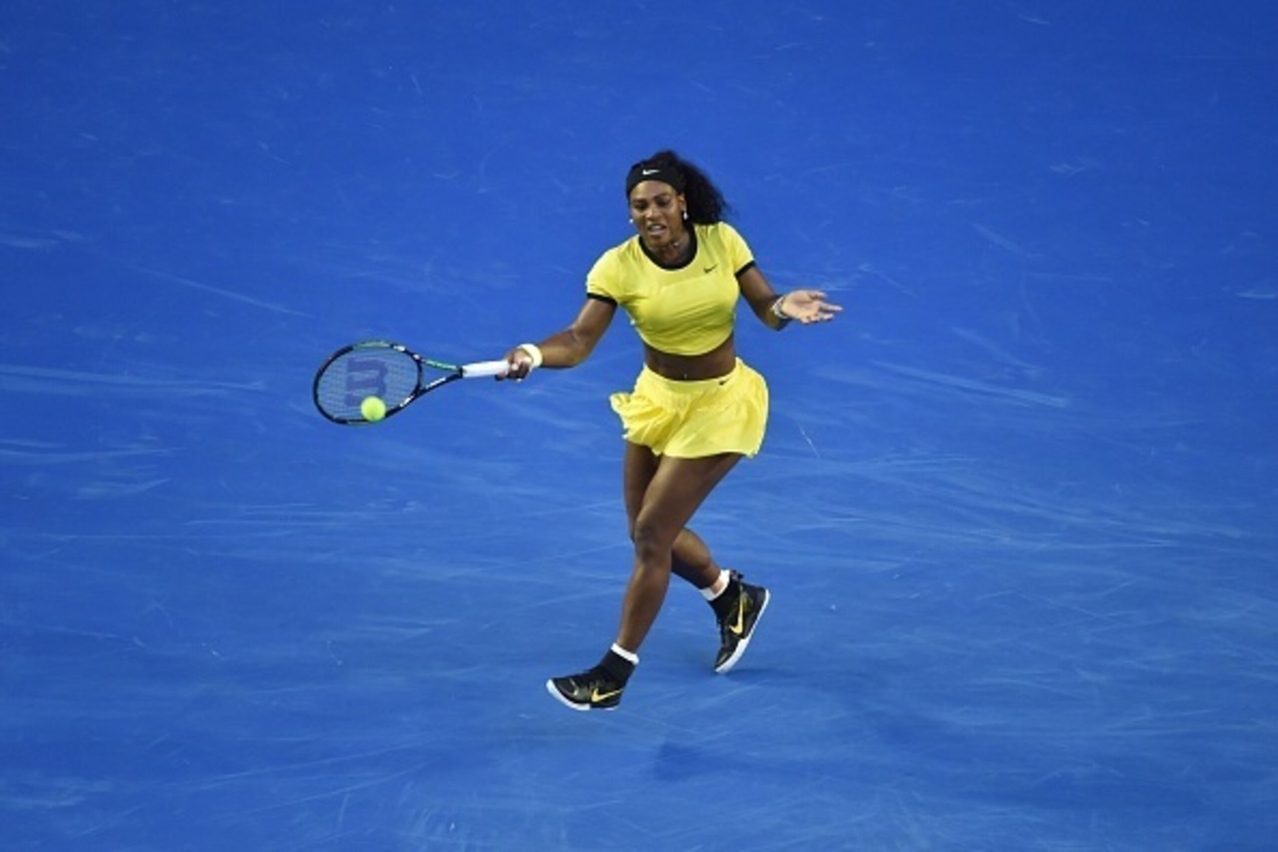 Serena Williams of the US hits a return during her women's singles match against Russia's Daria Kasatkina on day five of the 2016 Australian Open tennis tournament in Melbourne on January 22, 2016. AFP PHOTO / SAEED KHAN-- IMAGE RESTRICTED TO EDITORIAL US