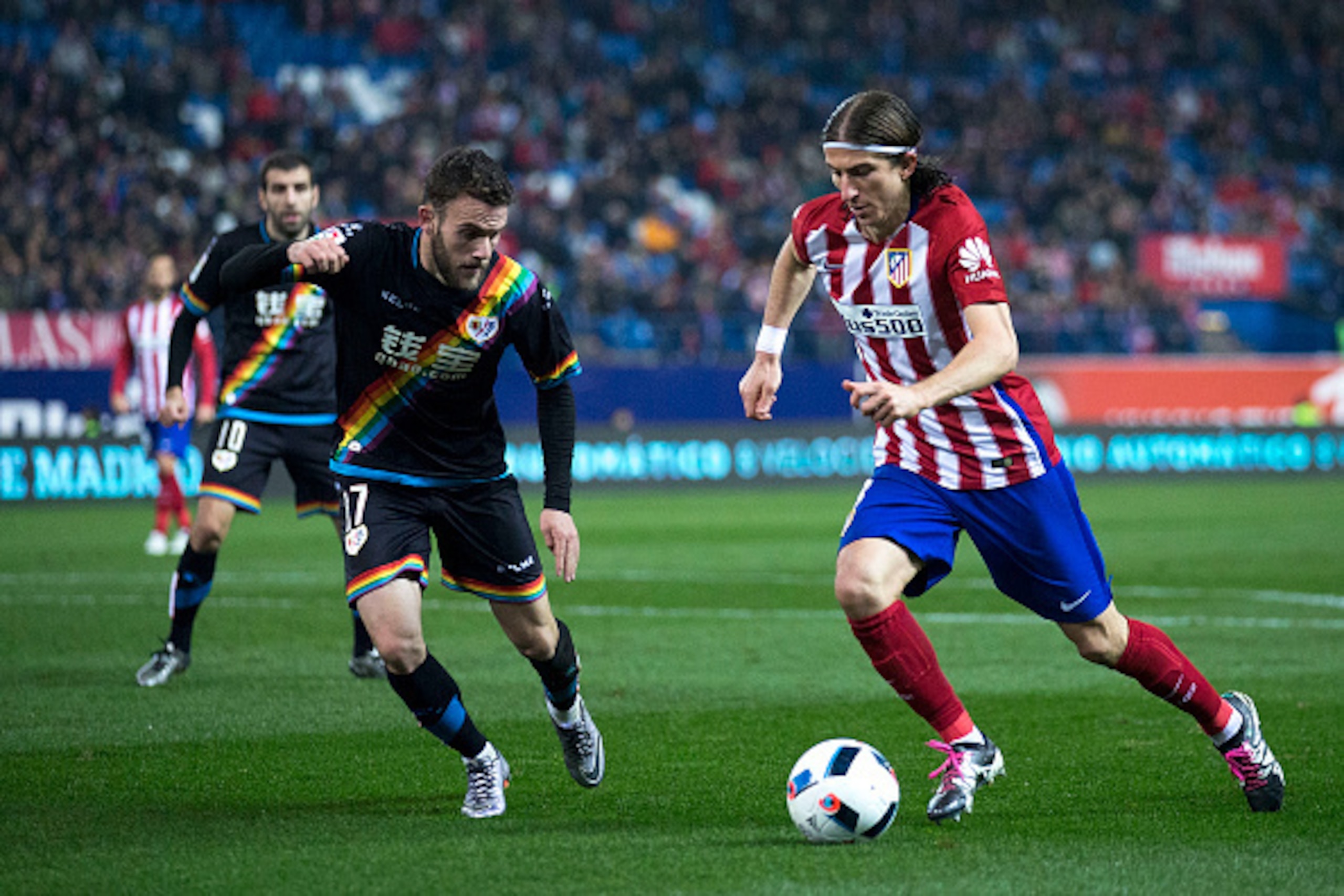 MADRID, SPAIN - JANUARY 14: Filipe Luis (R) of Atletico de Madrid competes for the ball with Joaquin Jose Marin alias Quini (L) of Rayo Vallecano de Madrid during the Copa del Rey Round of 16 second leg match between Club Atletico Madrid and Rayo Vallecan