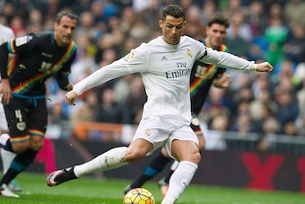 Real Madrid's Portuguese forward Cristiano Ronaldo scores from a penatly during the Spanish league football match Real Madrid CF vs Rayo Vallecano de Madrid at the Santiago Bernabeu stadium in Madrid on December 20, 2015.   AFP PHOTO/ CURTO DE LA TORRE / 