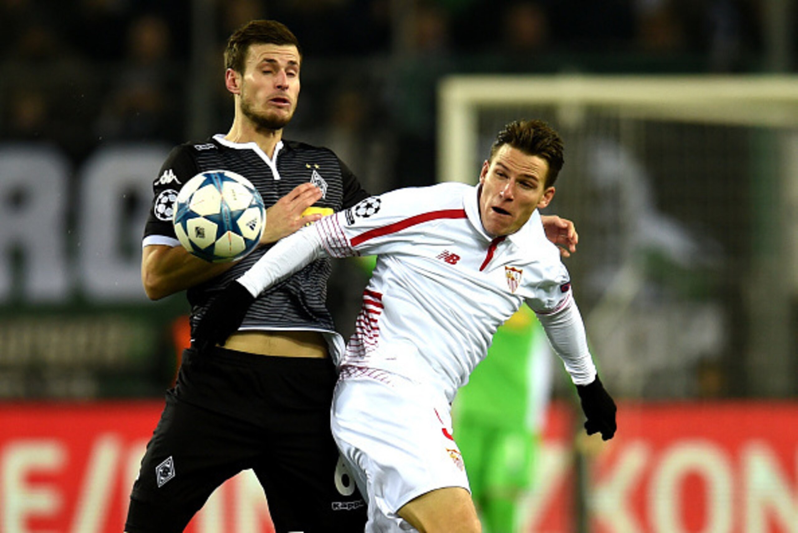 Moenchengladbach's Norwegian midfielder Havard Nordtveit (L) vies with Sevilla´s Kevin Gameiro during the Group D, second-leg UEFA Champions League football match Borussia Moenchengladbach vs FC Sevilla in Moenchengladbach, western Germany on November 25,