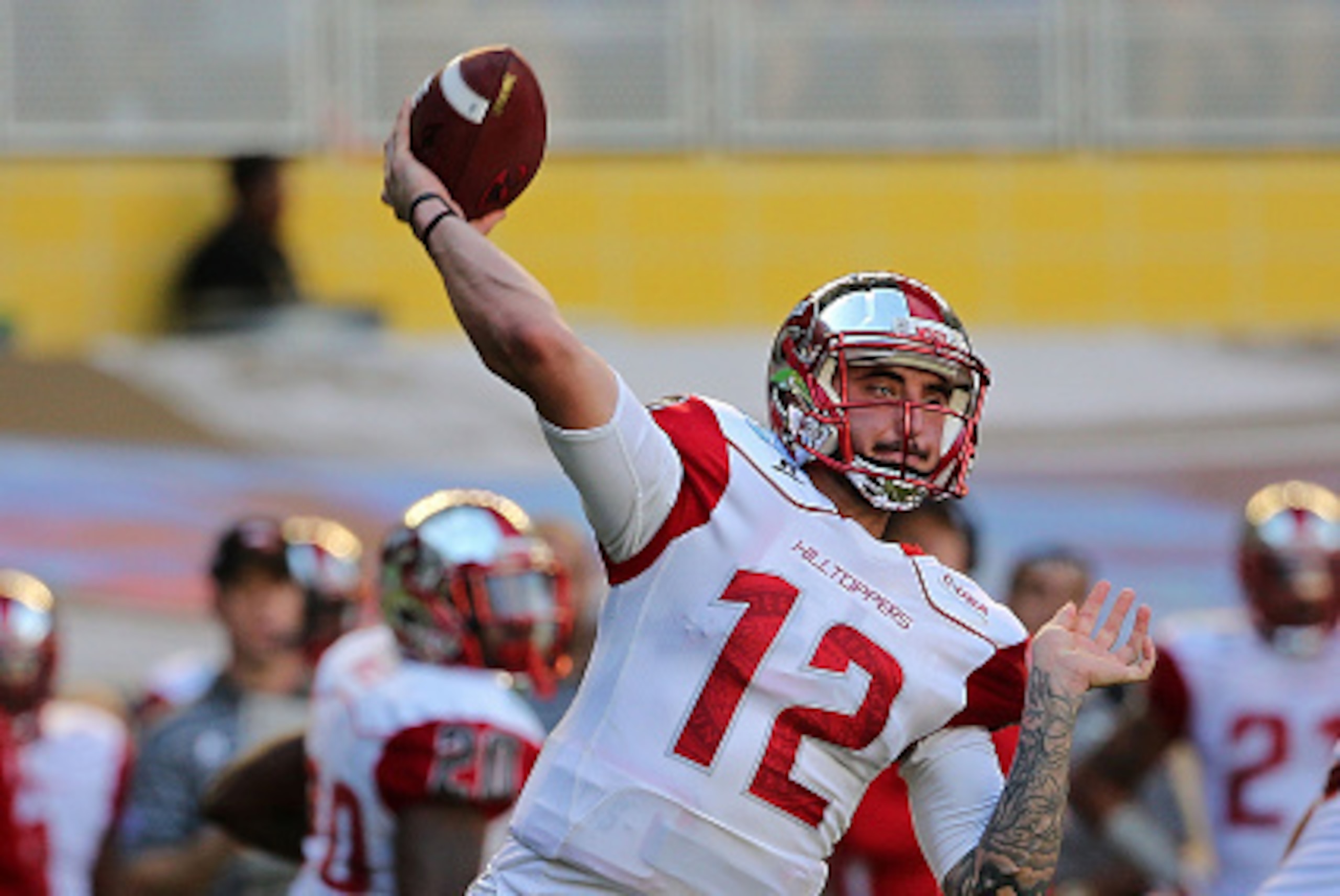 MIAMI, FL - DECEMBER 21:  Brandon Doughty #12 of the Western Kentucky Hilltoppers passes during the 2015 Miami Beach Bowl against the South Florida Bulls at Marlins Park on December 21, 2015 in Miami, Florida.  (Photo by Mike Ehrmann/Getty Images)