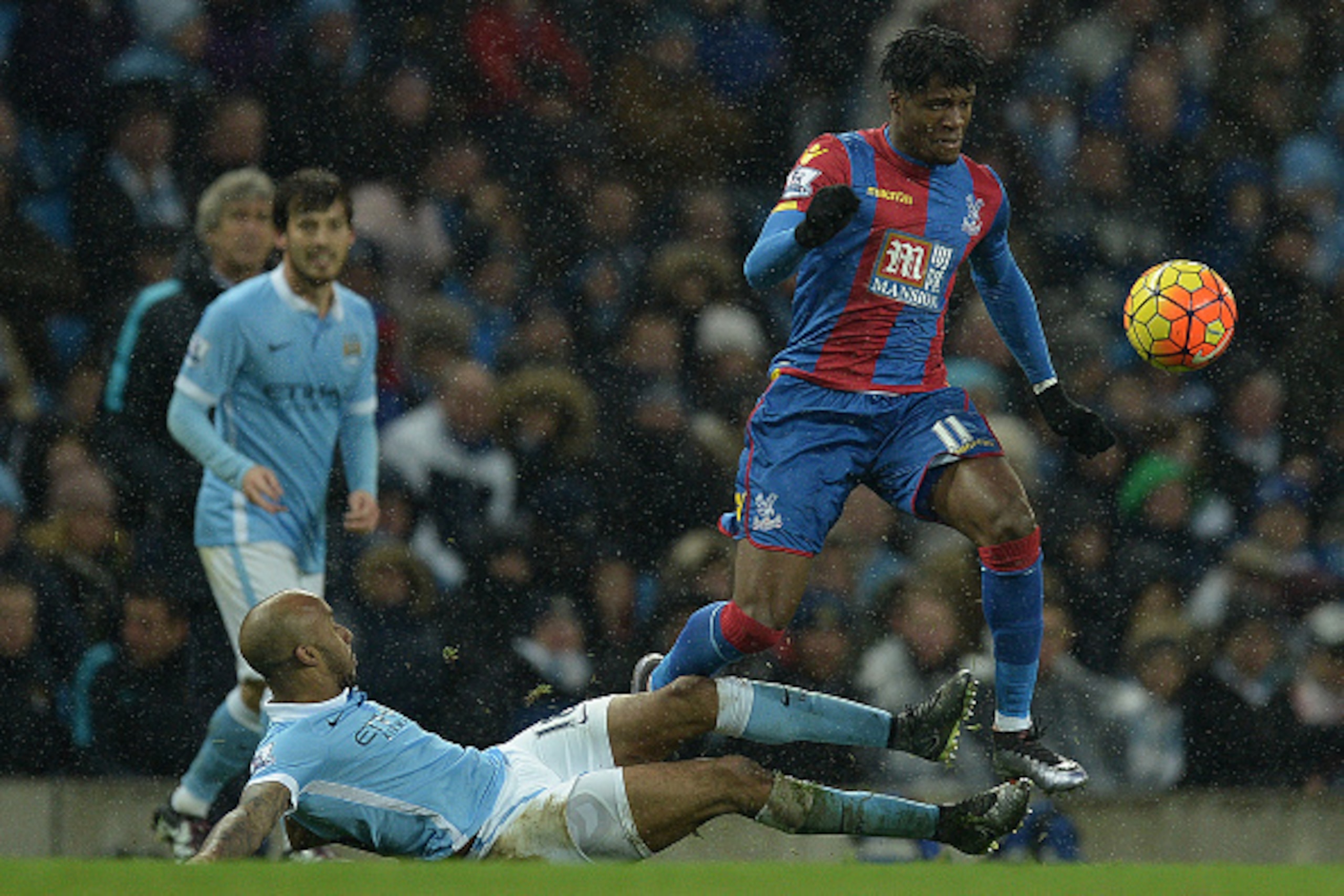 Manchester City's English midfielder Fabian Delph (C) vies with Crystal Palace's Ivorian-born English striker Wilfried Zaha during the English Premier League football match between Manchester City and Crystal Palace at the Etihad Stadium in Manchester, no Manchester City's English midfielder Fabian Delph (C) vies with Crystal Palace's Ivorian-born English striker Wilfried Zaha during the English Premier League football match between Manchester City and Crystal Palace at the Etihad Stadium in Manchester, no