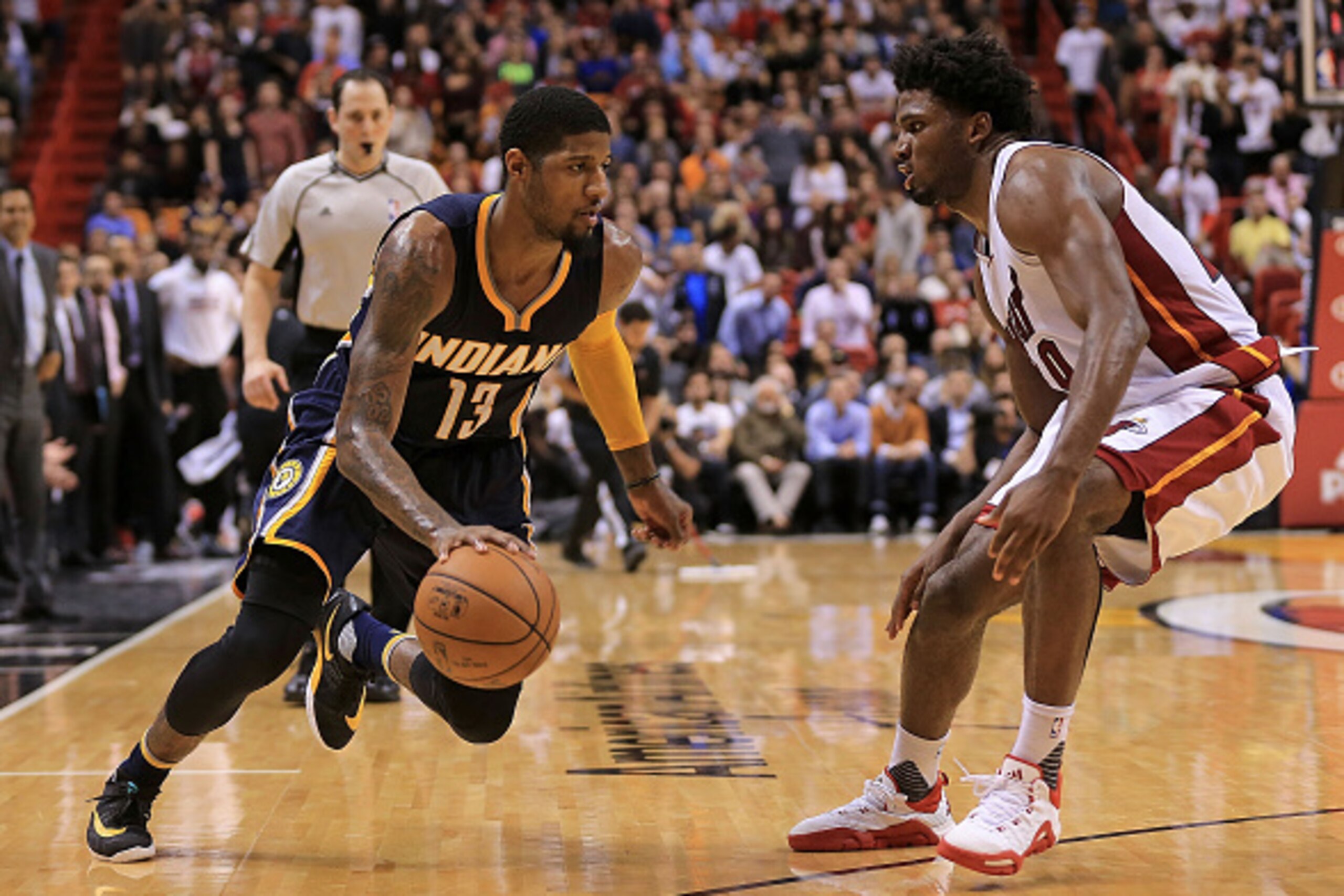MIAMI, FL - JANUARY 04:  Paul George #13 of the Indiana Pacers drives on Justise Winslow #20 of the Miami Heat during a game  at American Airlines Arena on January 4, 2016 in Miami, Florida. NOTE TO USER: User expressly acknowledges and agrees that, by do