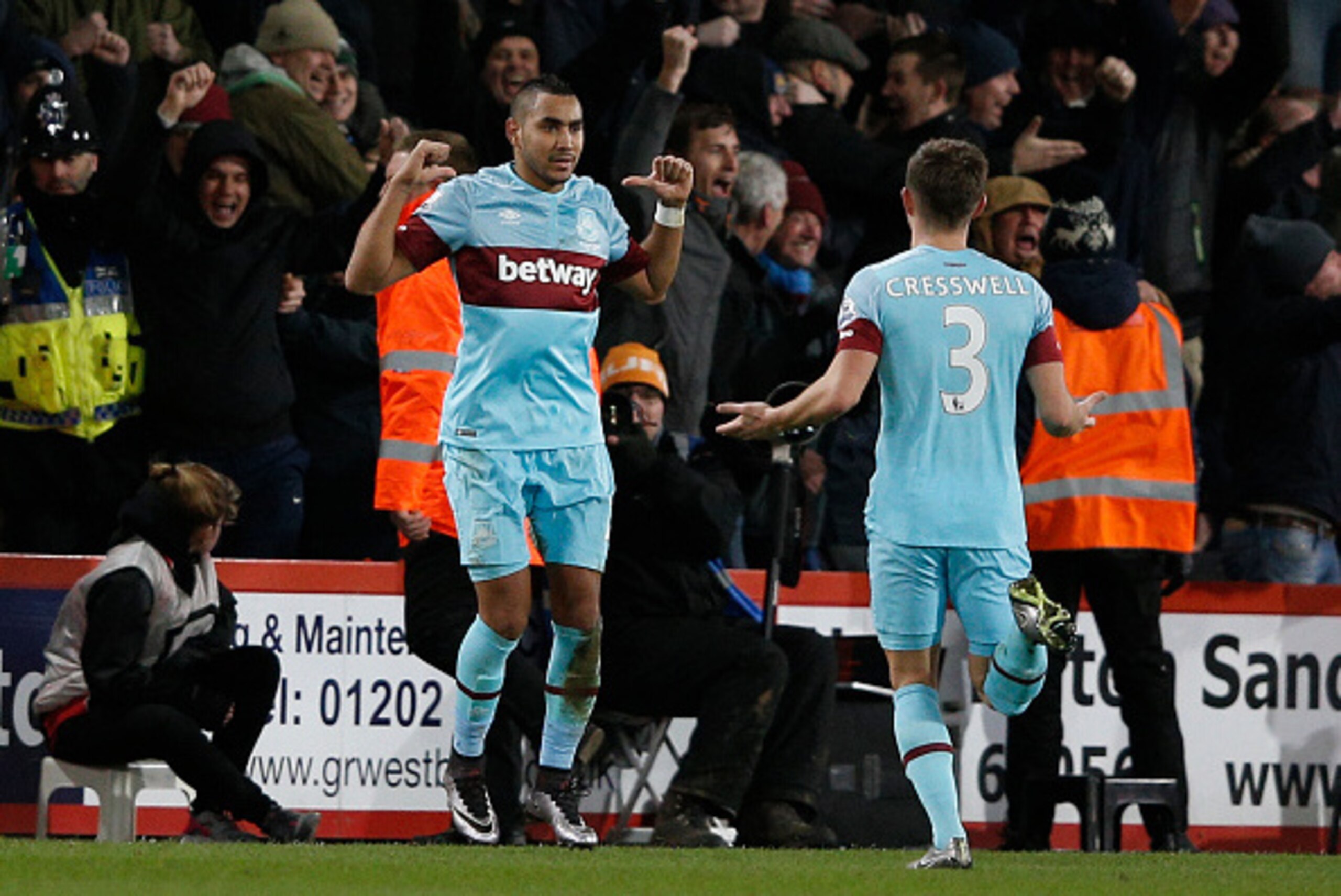 West Ham United's French midfielder Dimitri Payet (L) celebrates after scoring during the English Premier League football match between Bournemouth and West Ham United at the Vitality Stadium in Bournemouth, southern England on January 12, 2016. AFP PHOTO