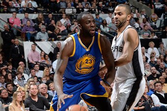 SAN ANTONIO, TX - APRIL 5: Draymond Green #23 of the Golden State Warriors handles the ball against Tony Parker #9 of the San Antonio Spurs on April 5, 2015 at the AT&T Center in San Antonio, Texas. NOTE TO USER: User expressly acknowledges and agrees tha