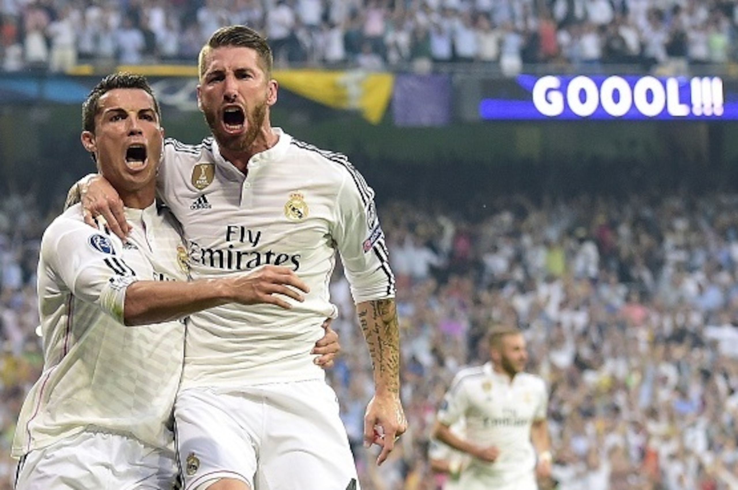 Real Madrid's Portuguese forward Cristiano Ronaldo (L) celebrates with Real Madrid's defender Sergio Ramos after scoring during the UEFA Champions League semi-final second leg football match Real Madrid FC vs Juventus at the Santiago Bernabeu stadium in M