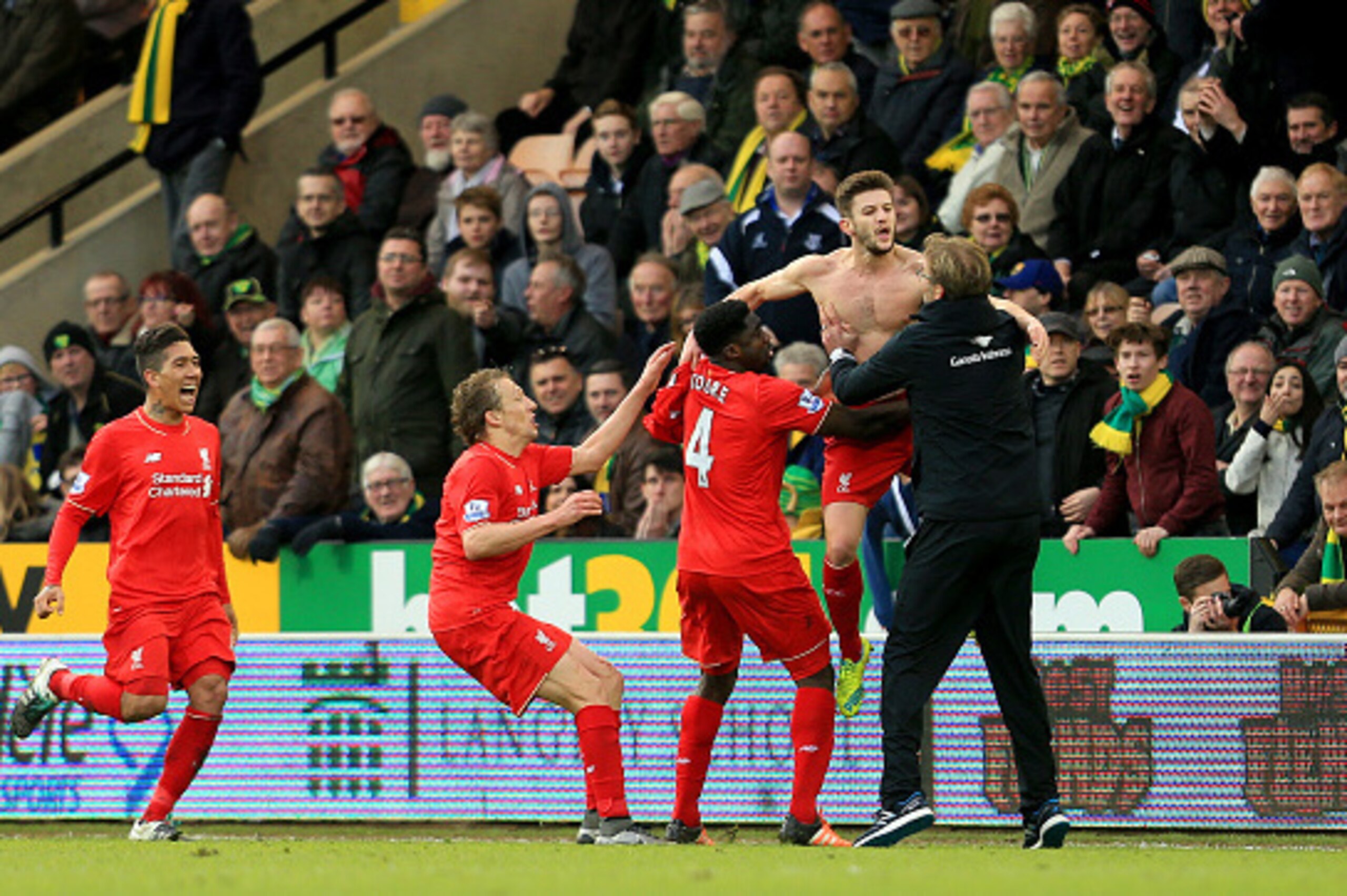 NORWICH, ENGLAND - JANUARY 23:  Adam Lallana (2nd R) of Liverpool ceelbrates scoring his team's fifth goal with his manager Jurgen Klopp (1st R) and team mate Kolo Toure (3rd R), Lucas Leiva (2nd L) and Roberto Firmino (1st L) during the Barclays Premier 