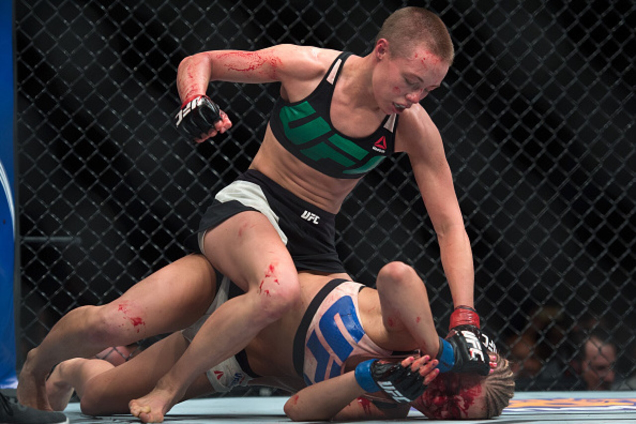 LAS VEGAS, NEVADA - DECEMBER 10:  (Top) Rose Namajunas punches Paige VanZant in their women's strawweight bout during the UFC Fight Night event at The Chelsea at the Cosmopolitan of Las Vegas on December 10, 2015 in Las Vegas, Nevada.  (Photo by Brandon M